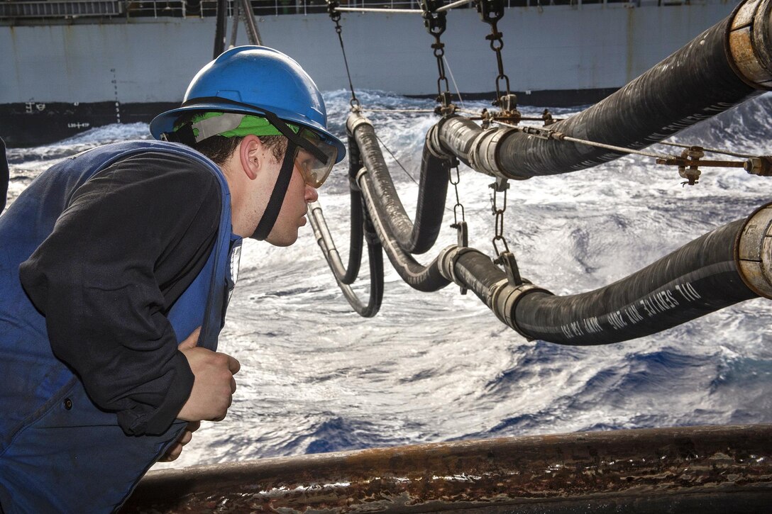 Navy Petty Officer 3rd Class Dustin Bruner monitors a fuel line during a replenishment-at-sea between the aircraft carrier USS Carl Vinson and the fleet replenishment oiler USNS Pecos in the Pacific Ocean, Feb. 3, 2017. Bruner is a boatswain’s mate. Navy photo by Petty Officer 2nd Class Sean M. Castellano