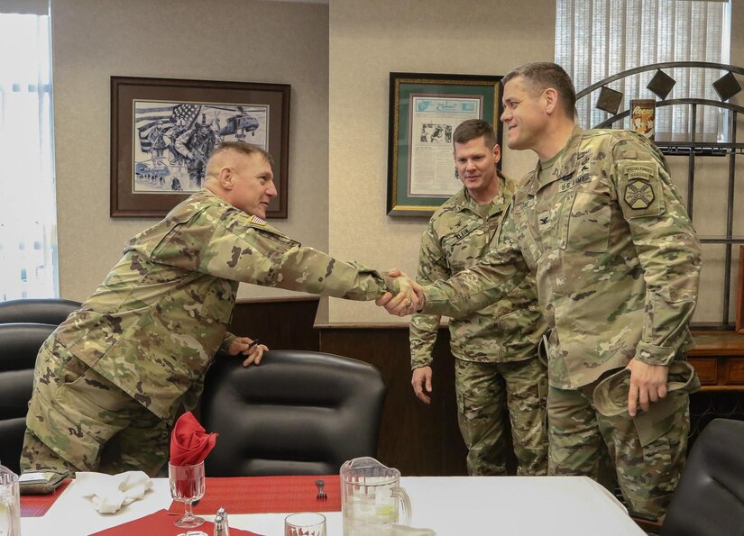 Maj. Gen. Troy D. Kok, Commander of the 99th Regional Support Command headquartered at Joint Base McGuire-Dix-Lakehurst greets Col. Bryan J. Laske, the Fort Drum Garrison Commander Feb. 8 at Buster's Brew Pub on post. 
