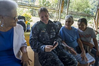 PUERTO BARRIOS, Guatemala  (Feb. 7, 2017) - Chief Musician Erin Horn, a native of Norwood, N.Y., attached to U.S. Fleet Forces (USFF) Band, Norfolk, Va., shares family photos with host nation residents during a visit to a community center for senior-citizens in support of Continuing Promise 2017’s (CP-17) visit to Puerto Barrios, Guatemala. CP-17 is a U.S. Southern Command-sponsored and U.S. Naval Forces Southern Command/U.S. 4th Fleet-conducted deployment to conduct civil-military operations including humanitarian assistance, training engagements, and medical, dental, and veterinary support in an effort to show U.S. support and commitment to Central and South America. (U.S. Navy photo by Mass Communication Specialist 2nd Class Shamira Purifoy)