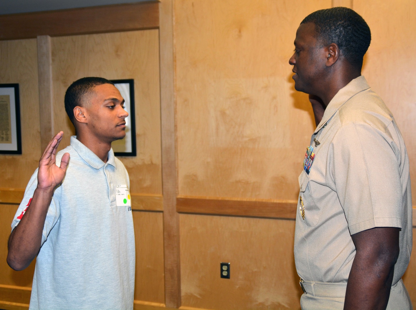 Reginal A. Fisher Jr. (left) , a 2016 graduate of Allison Steele High School in Cibolo, Texas, enlisted into the U.S. Navy as a hospital corpsman at the San Antonio Military Entrance Processing Station at Joint Base San Antonio-Fort Sam Houston.  His father, Lt. Reginal A. Fisher Sr., a native of Longview, Texas, and the enlisted operations officer for Navy Recruiting District San Antonio, administered the Oath of Enlistment.  Future Sailor Fisher will become the fifth generation serviceman in his family.  His great-great grandfather, Pfc. Tinzer Morrow, served in the Army during WWI; his great grandfather, Cpl. Willie Lee Fisher, served in the Army Air Corps in WWII; his grandfather, Cpl. James Lewis Fisher, served in the Army during the Vietnam War; and his father, who served in OPERATION IQAQI FREEDOM/ENDURRING FREEDOM. 