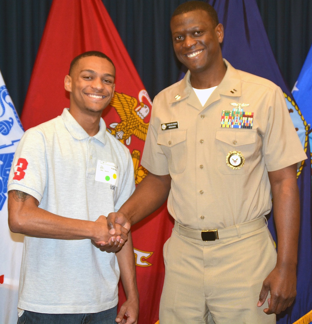 Reginal A. Fisher Jr. (left), a 2016 graduate of Allison Steele High School in Cibolo, Texas, enlisted into the U.S. Navy as a hospital corpsman at the San Antonio Military Entrance Processing Station.  His father, Lt. Reginal A. Fisher Sr., a native of Longview, Texas, and the enlisted operations officer for Navy Recruiting District San Antonio, administered the Oath of Enlistment.  Future Sailor Fisher will become the fifth generation serviceman in his family.  His great-great grandfather, Pfc. Tinzer Morrow, served in the Army during WWI; his great grandfather, Cpl. Willie Lee Fisher, served in the Army Air Corps in WWII; his grandfather, Cpl. James Lewis Fisher, served in the Army during the Vietnam War; and his father, who served in OPERATION IQAQI FREEDOM/ENDURRING FREEDOM.