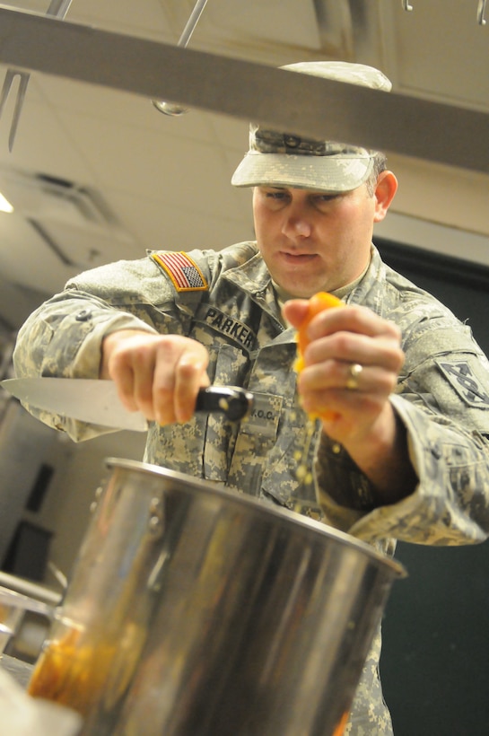 Army Reserve Warrant Officer Candidate Joseph Parker, a Food Service NCO for the 143rd Sustainment Command (Expeditionary), juices an orange while preparing a meal out of a mobile kitchen trailer at the Orlando Armed Forces Reserve Center. Parker and the Army Reserve Culinary Arts Team were rehearsing for the upcoming 42nd Annual Military Culinary Arts Competition.