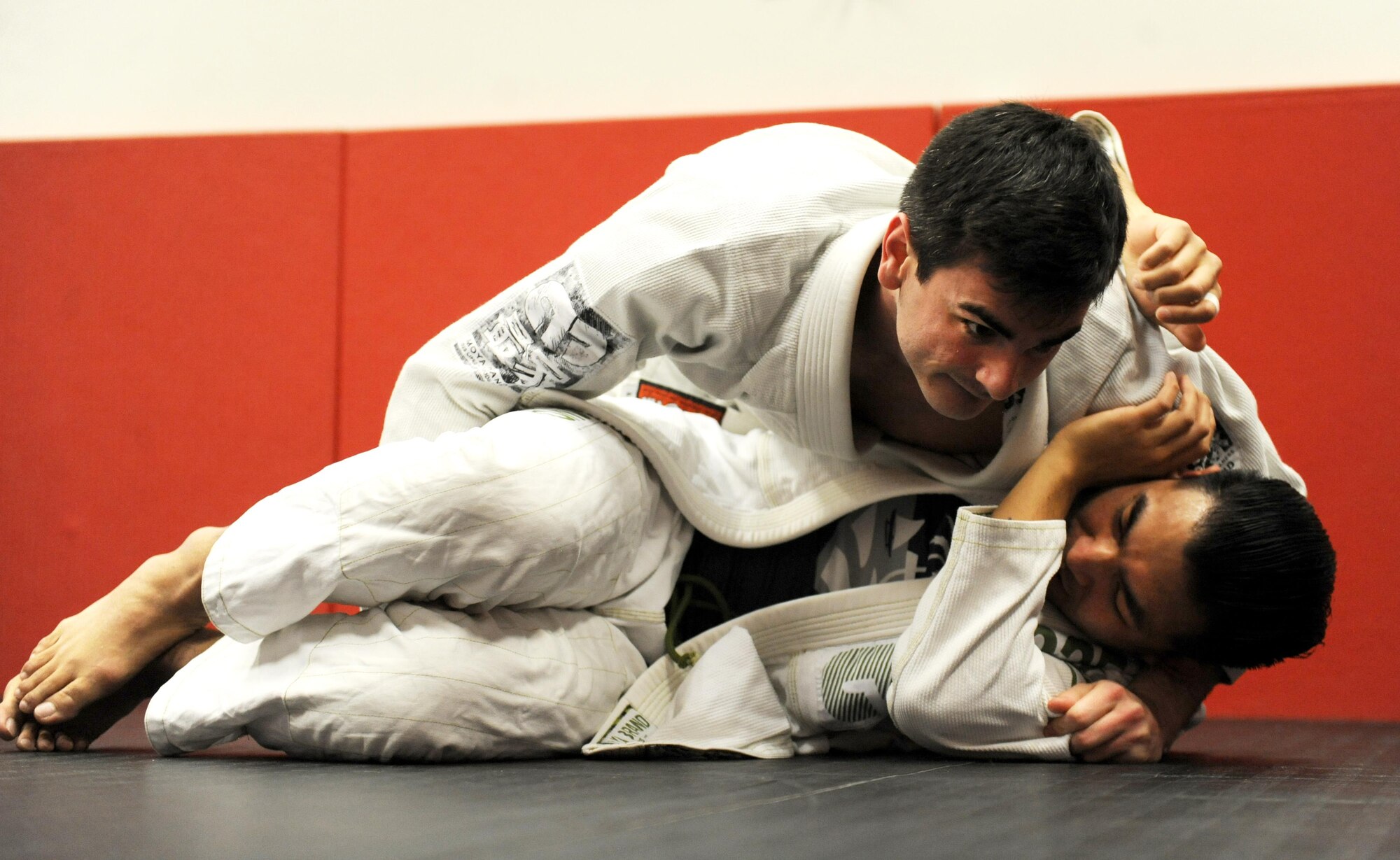 Joshua Joseph, top, takes side control of Patrick Celeste, both students, during the Brazilian Jiu Jitsu class at the fitness center on Whiteman Air Force Base, Mo., Jan. 20, 2017. Students learn the martial art technique of ground fighting during the weekly class offered to adults and youth. (U.S. Air Force photo by Tech. Sgt. Miguel Lara)