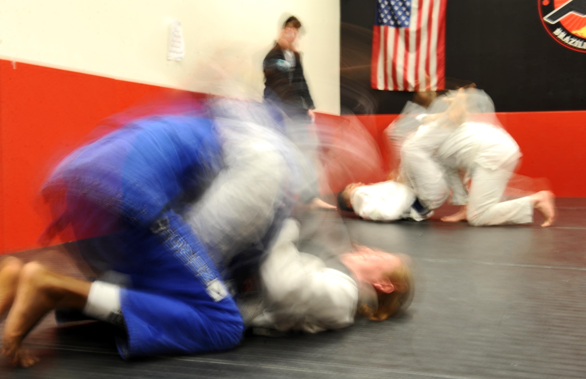 Members of Team Whiteman spar during a Brazilian Jiu Jitsu class at the fitness center on Whiteman Air Force Base, Mo., Jan. 30, 2017. Brazilian Jiu Jitsu, a ground based martial art, teaches practitioners to fight from their backs. Adult and youth classes are offered weekly at the Whiteman fitness center. (U.S. Air Force photo by Tech. Sgt. Miguel Lara)