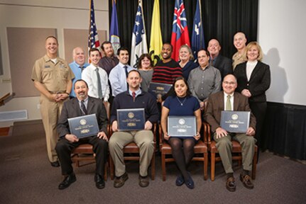 2016 Naval Sea Systems Command Warfare Center Awards were presented on Feb. 2 at NUWC Division Newport. Awards were presented by Rear Adm. Moises DelToro III (far left), commander, NUWC, Mary Wohlgemuth (far right), SES, technical director, NUWC Newport; and Capt. Geoffrey deBeauclair (back row, second from right), commanding officer, NUWC Newport.
