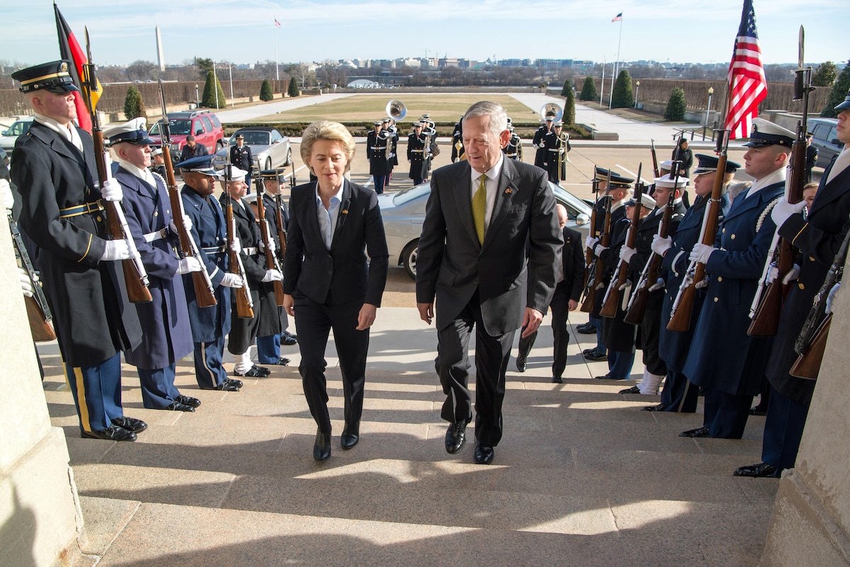 Defense Secretary James N. Mattis walks up steps with the German defense minister.