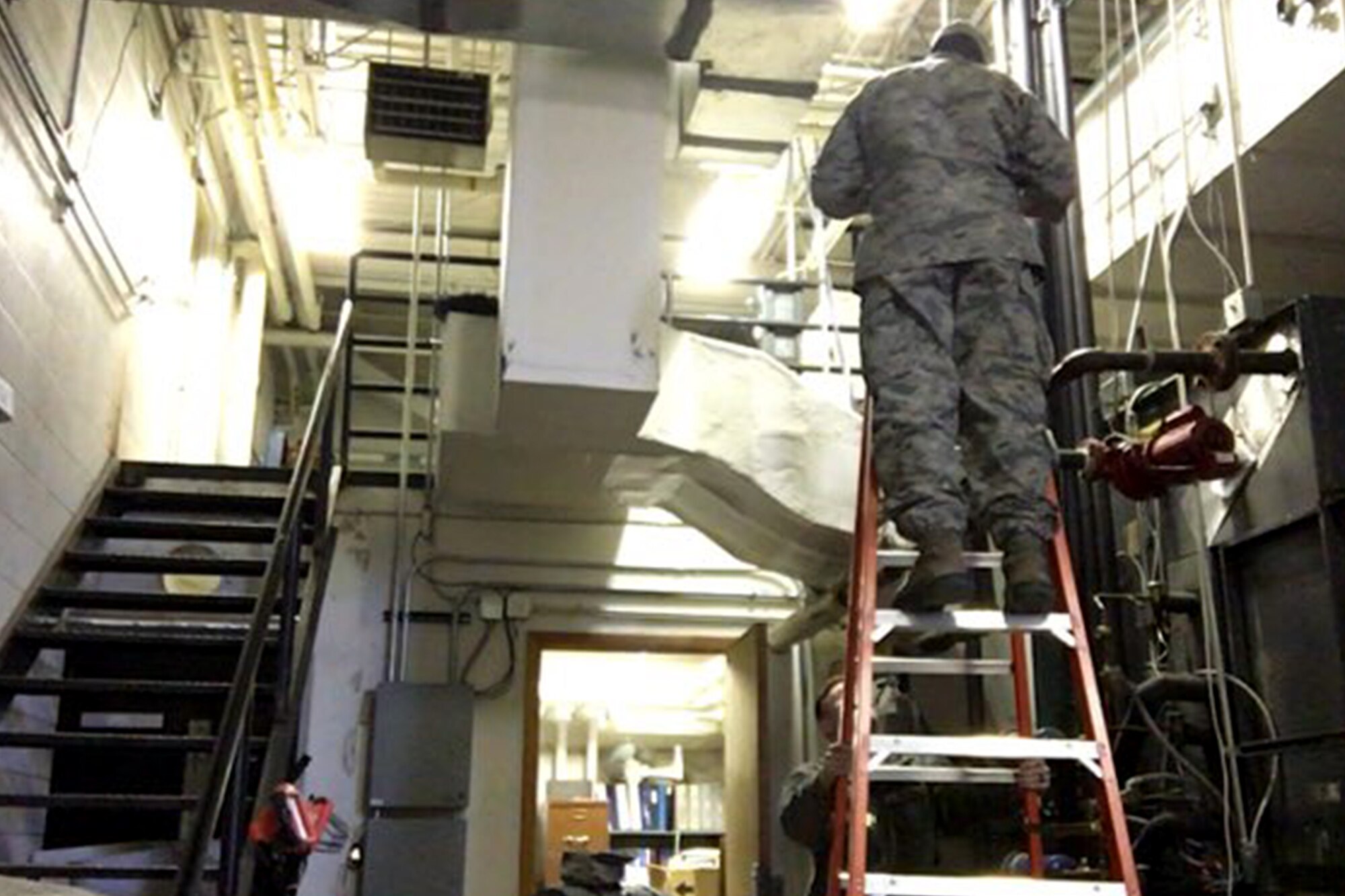 PETERSON AIR FORCE BASE, Colo. – Staff Sgt. Brian Foxworth, 21st Civil Engineer Squadron Heating Ventilation Air Conditioning and Refrigeration craftsman, repairs a unit heater in the 21st CES compound’s mechanical room on Peterson Air Force Base, Colo., Jan. 11, 2017. The operations flight from 21st CES cancelled meetings and fitness training for a week in an attempt to get the backlog of work orders under control. (Courtesy photo)