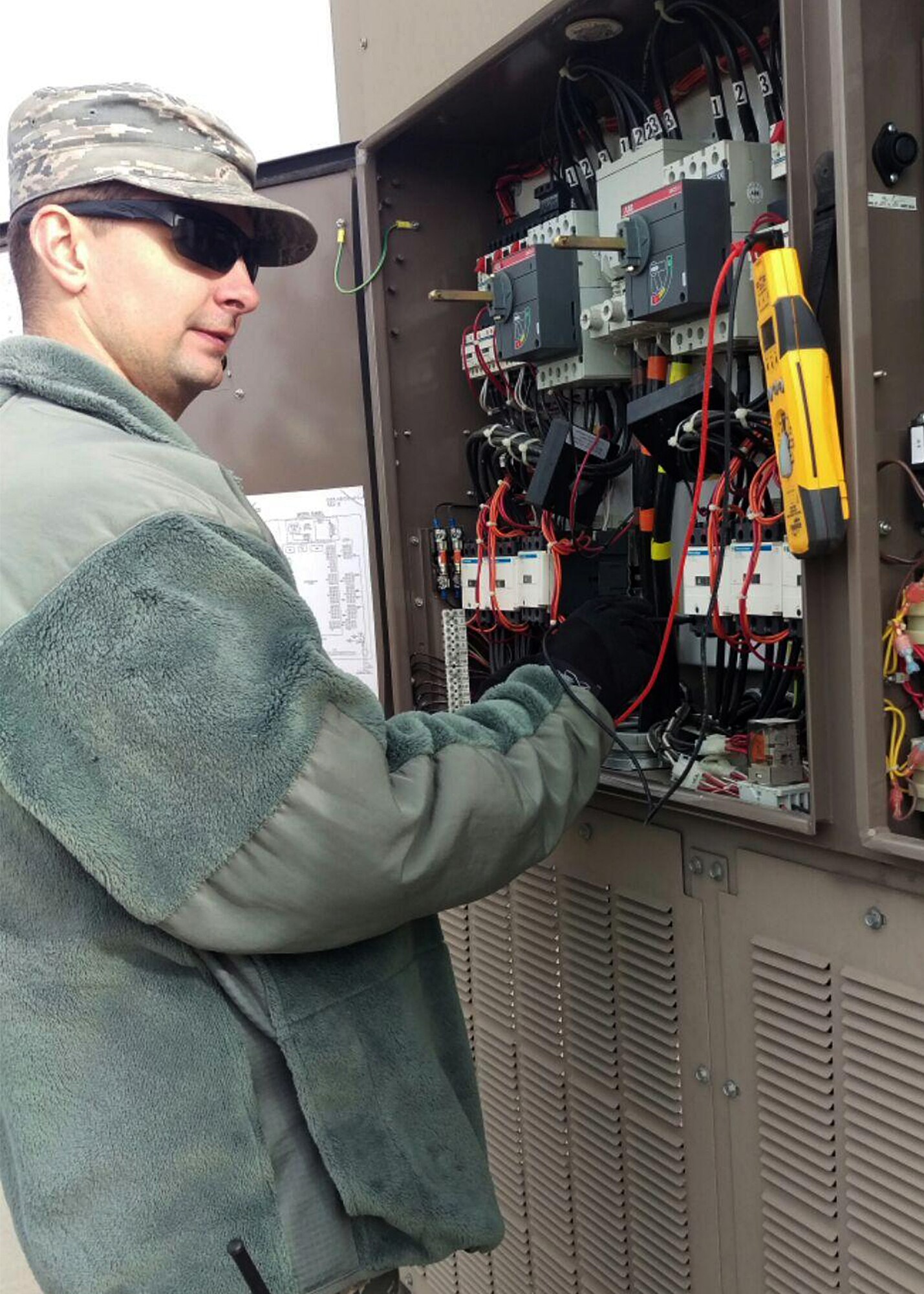 PETERSON AIR FORCE BASE, Colo. – Staff Sgt. Christopher Stevenson, 21st Civil Engineer Squadron Heating Ventilation Air Conditioning and Refrigeration craftsman, troubleshoots electrical wiring for a chiller at Air Force Life Cycle Material Command on Peterson Air Force Base, Colo., Jan. 12, 2017. The operations flight from 21st CES cancelled meetings and fitness training for a week to attempt to get the backlog of work orders under control. (Courtesy photo)
