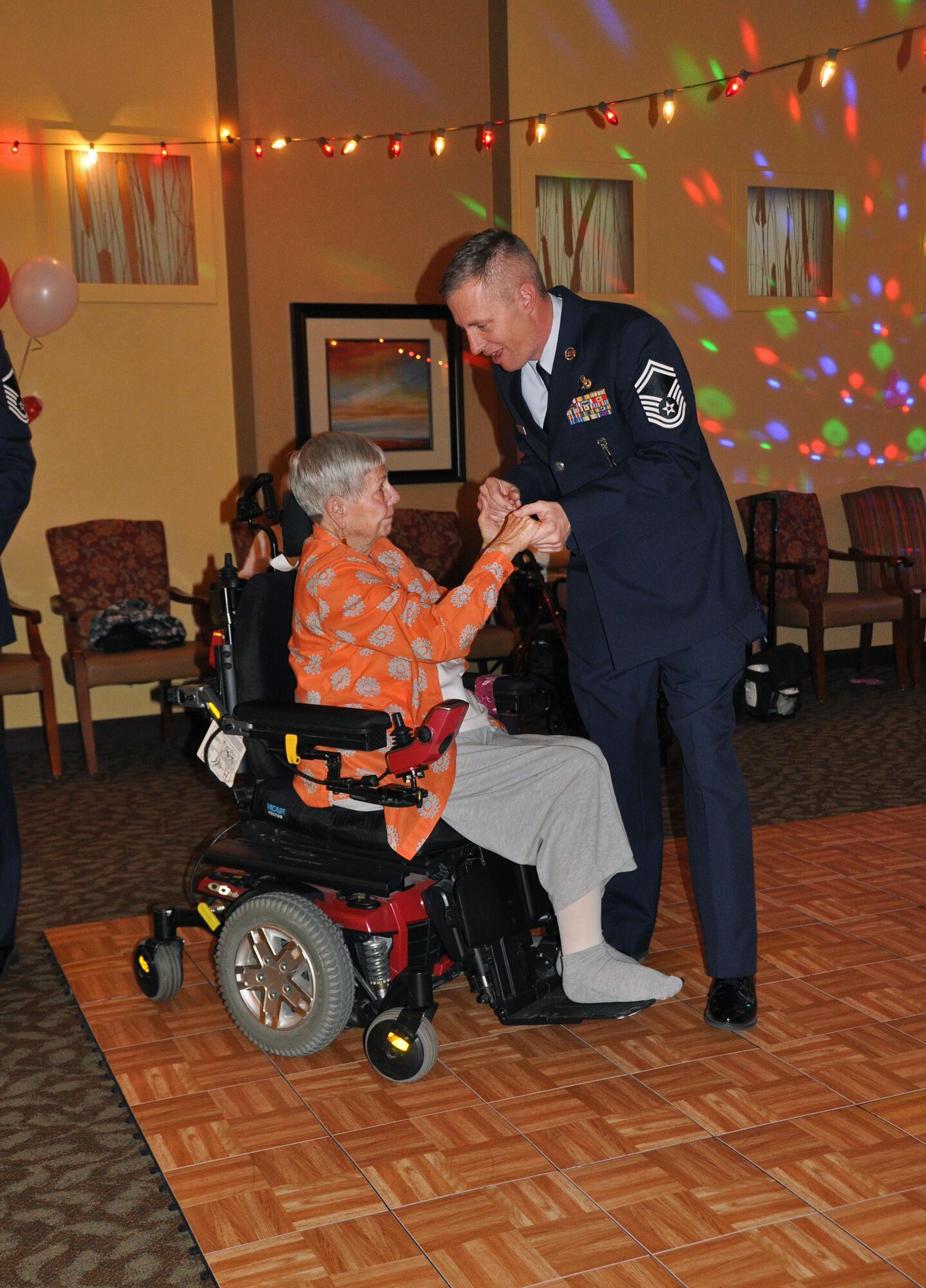 Senior Master Sgt. Brian Christensen, 419th Aircraft Maintenance Squadron, dances with Jean, a resident of Chancellor Gardens, during the assisted living facility’s Valentine’s Day dance Feb. 9. Several Airmen from the 419th Fighter Wing and their families volunteered to be dance partners for the evening. (U.S. Air Force photo/Bryan Magaña)