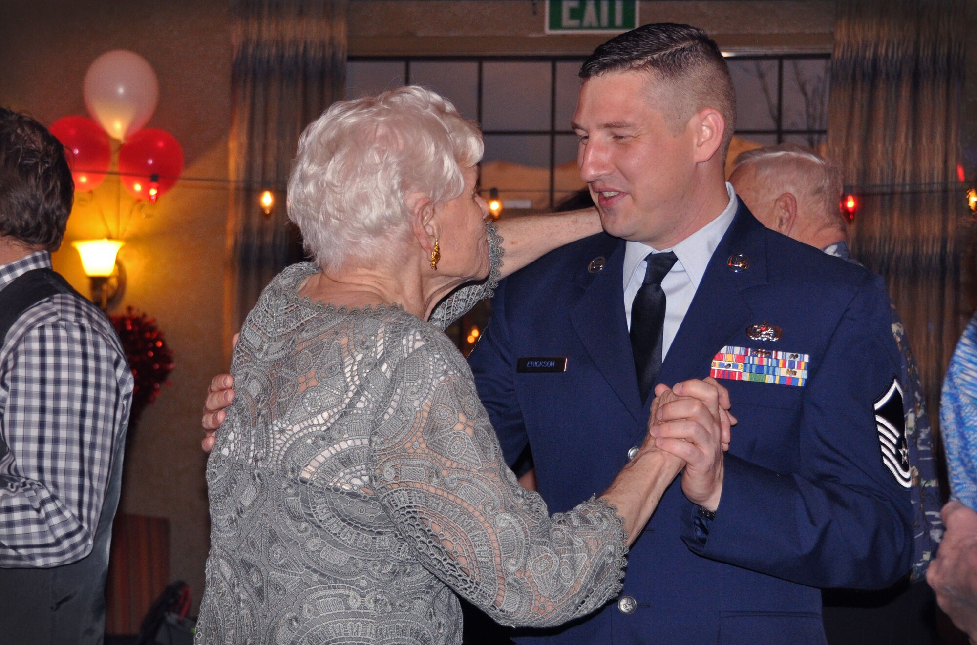 Master Sgt. Blake Erickson, 67th Aerial Port Squadron, dances with Barbara, a resident of Chancellor Gardens, during the assisted living facility’s Valentine’s Day dance Feb. 9. Several Airmen from the 419th Fighter Wing and their families volunteered to be dance partners for the evening. (U.S. Air Force photo/Bryan Magaña)