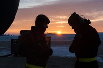 (From left) Senior Airman Daniel Hancock and Senior Airman Josh Serafin, 5th Aircraft Maintenance Squadron crew chiefs, try to stay warm before launching an aircraft at Minot Air Force Base, N.D., Jan 26, 2017. Crew chiefs arrive to the aircraft before the aircrew to perform pre-flight inspections to ensure a safe launch. (U.S. Air Force photo/Senior Airman J.T. Armstrong)