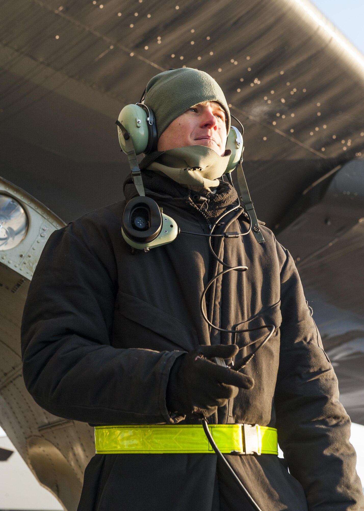 Senior Airman Josh Serafin, 5th Aircraft Maintenance Squadron crew chief, communicates with the aircrew aboard a B-52H Stratofortress prior to launch at Minot Air Force Base, N.D., Jan. 26, 2017. Communication between the aircrew aboard the aircraft and the maintainers outside, is critical to safely launching a B-52. (U.S. Air Force photo/Senior Airman J.T. Armstrong)