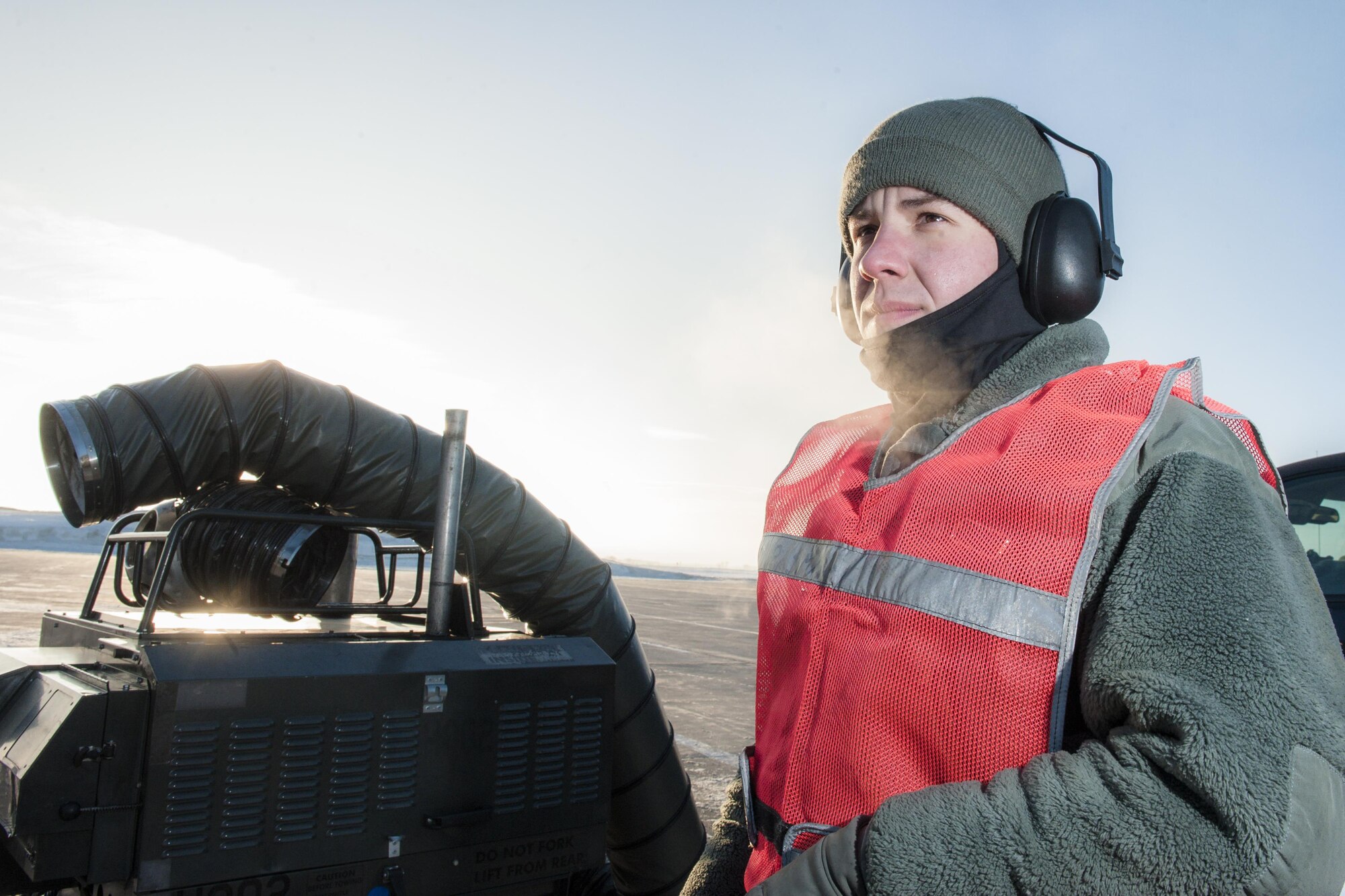 Senior Airman Daniel Hancock, 5th Aircraft Maintenance Squadron crew chief, watches at a B-52H Stratofortress starts its engines at Minot Air Force Base, N.D., Jan. 26, 2017. Hancock, along with other 5th AMXS Airmen, work in harsh weather conditions to provide B-52 firepower on demand. (U.S. Air Force photo/Senior Airman J.T. Armstrong)
