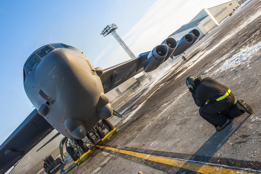 Senior Airman Josh Serafin, 5th Aircraft Maintenance Squadron crew chief, monitors the ignition of eight B-52H Stratofortress engines at Minot Air Force Base, N.D., Jan. 26, 2017. Crew chiefs from the 5th AMXS are responsible for pre-flight inspections, safely launching and recovering the aircraft, as well as overseeing post-flight maintenance. (U.S. Air Force photo/Senior Airman J.T. Armstrong)