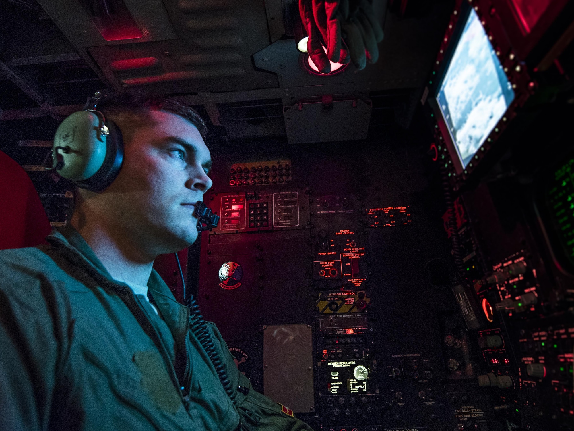1st Lt. Alex Johnson, 23rd Bomb Squadron weapons system officer, analyses a multi-function color display inside a B-52H Stratofortress above North Dakota, Jan. 31, 2017. Johnson along with another weapons system officer, sit in the offense compartment of the aircraft, controlling the B-52’s weapons capabilities. (U.S. Air Force photo/Senior Airman J.T. Armstrong)