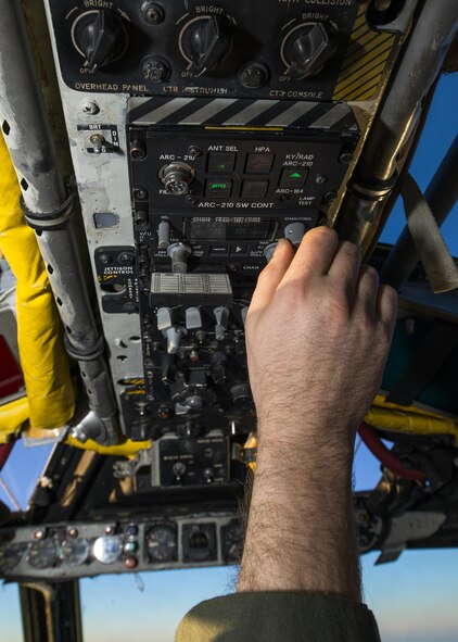 Capt. Dane Weathers, 23rd Bomb Squadron aircraft commander, changes radio frequency inside a B-52H Stratofortress above the clouds in North Dakota airspace, Jan. 31, 2017. Weathers and Capt. Jonathan Gabriel, 23rd BS aircraft commander, worked with their offensive and defensive team to successfully complete a training mission in preparation to support Operation Inherent Resolve. (U.S. Air Force photo/Senior Airman J.T. Armstrong)