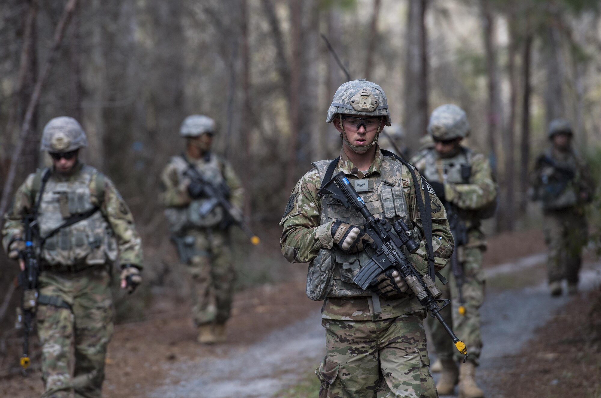Airmen from the 822d Base Defense Squadron simulate patrolling an area outside the wire Feb. 7, 2017, at Moody Air Force Base, Ga. This scenario was a part of the 822d BDS’s Tactical Operation Center Exercise. The exercise is designed to test communication and decision making between leadership in a control center and Airmen outside the wire. (U.S. Air Force photo by Airman 1st Class Janiqua P. Robinson)