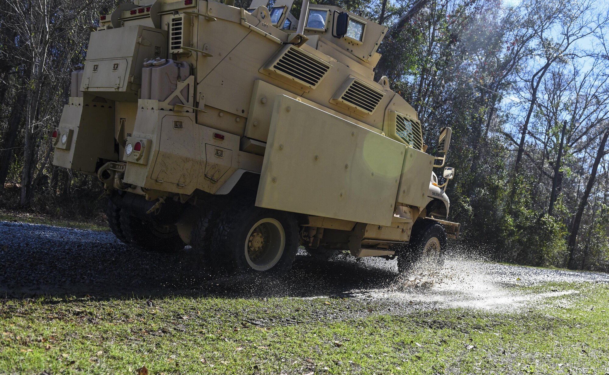 A Mine-Resistant Ambush Protected vehicle races out of a village after a simulated raid, Feb. 9, 2017, at Moody Air Force Base, Ga. This scenario was a part of the 822d BDS’s Tactical Operation Center Exercise. Airmen used intelligence they gathered during the week to find and neutralize hostile forces causing problems in a local village. (U.S. Air Force photo by Airman 1st Class Janiqua P. Robinson)