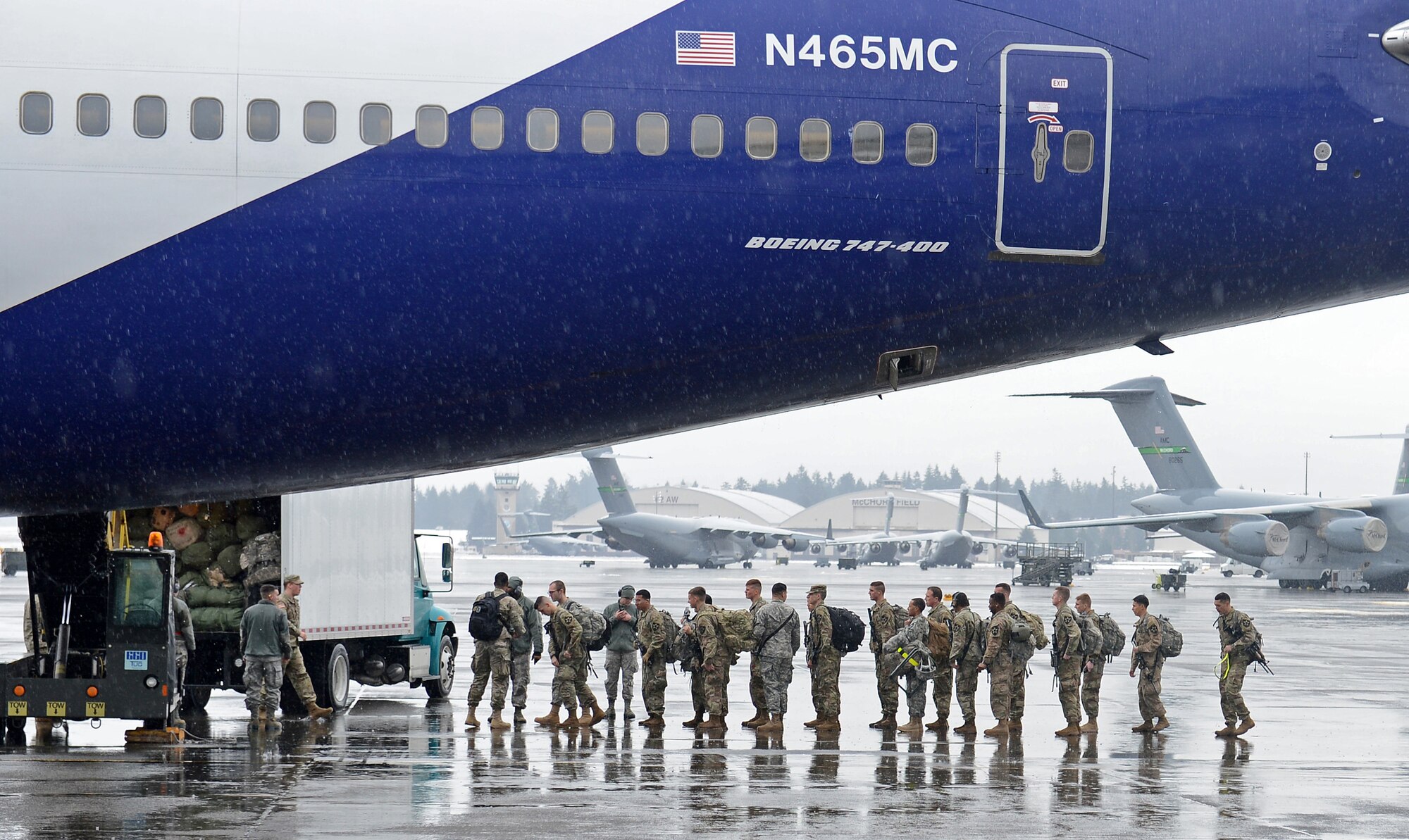 Airmen from the 62nd Aerial Port Squadron passenger service, escort Army soldiers from the 3rd Stryker Brigade to their aircraft Feb. 8, 2017 at Joint Base Lewis-McChord, Wash. The PAX terminal is one of four sections that the air terminal operations center coordinates through to get passengers and their cargo to the aircraft. (U.S. Air Force photo/Senior Airman Divine Cox)