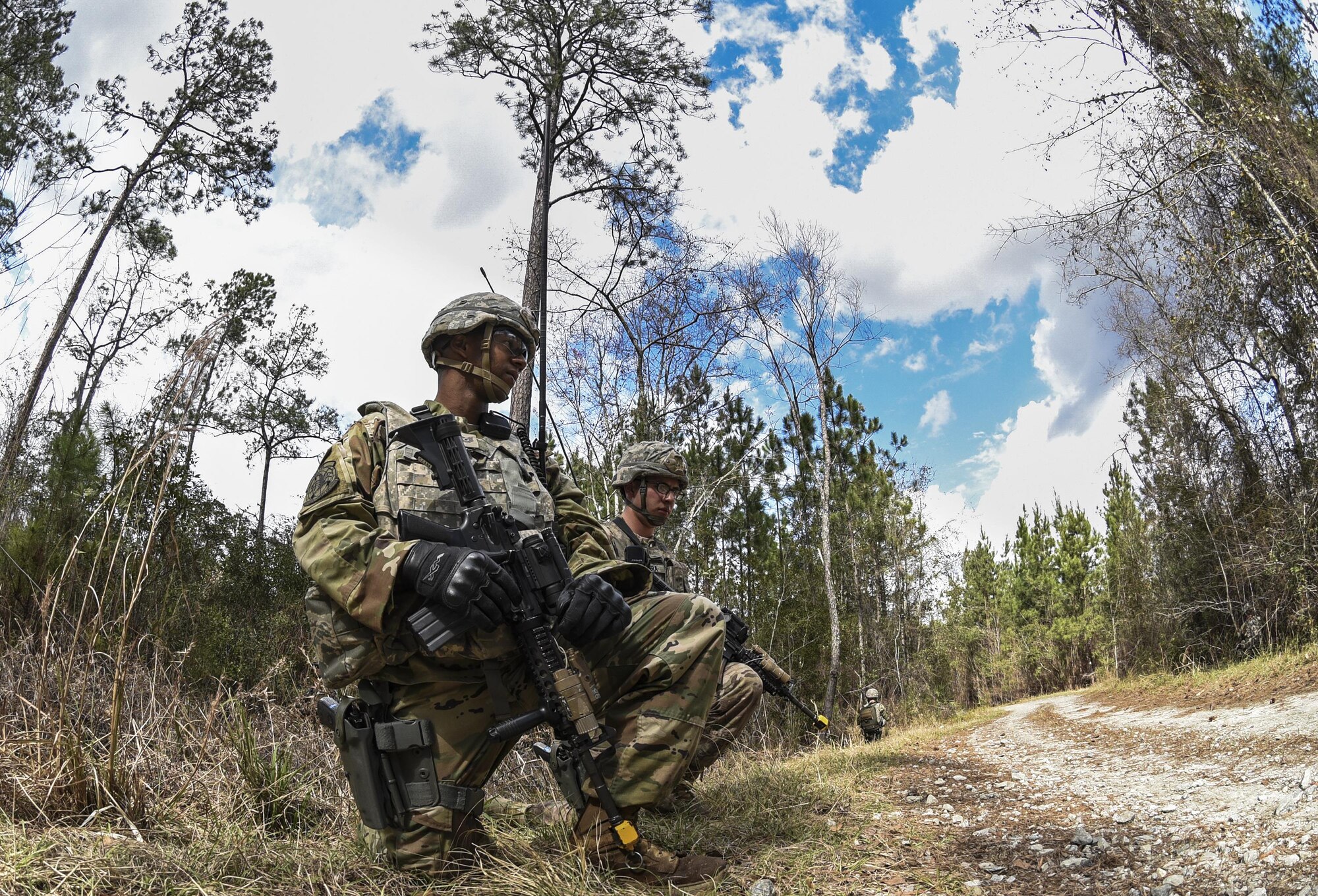 Tech. Sgt. Nicholas Jack, 822d Base Defense Squadron fireteam leader, takes a knee while awaiting instructions from leadership during a simulated patrol Feb. 7, 2017, at Moody Air Force Base, Ga. Once Jack relayed the information about the location of a found improvised explosive device, he had the rest of the team keep a look out for hostile forces and awaited direction from leadership. (U.S. Air Force photo by Airman 1st Class Janiqua P. Robinson)