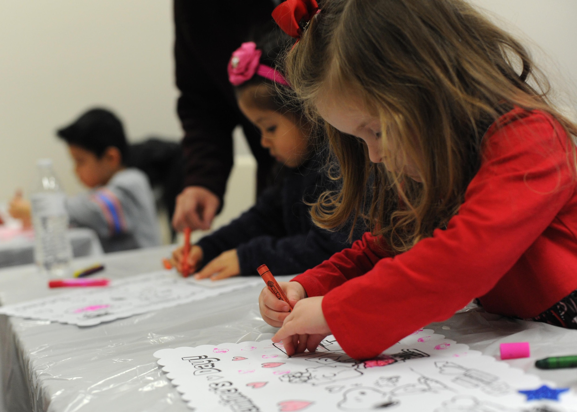 Siblings and members of the Exceptional Family Member Program craft together during the EFMP’s Valentine’s Day event Feb. 4, 2017, at the Airman & Family Readiness Center on Little Rock Air Force Base, Ark. The EFMP is comprised of healthcare providers and representatives who help members receive the care and attention they need. (U.S. Air Force photo by Airman 1st Class Grace Nichols)