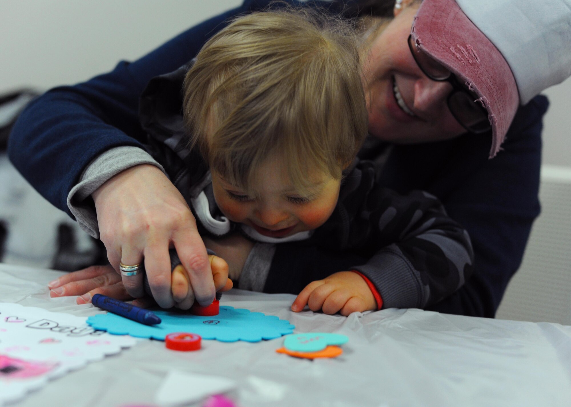 Brittany Boccher, Little Rock Air Force Base Key Spouses Club president, and her son, Blake, use a craft stamp Feb. 4, 2017, during the Exceptional Family Member Program’s Valentine’s Day event, at the Airman & Family Readiness Center on Little Rock Air Force Base, Ark. The event was an opportunity for parents to network and for children to play together in a relaxed environment. (U.S. Air Force photo by Airman 1st Class Grace Nichols)
