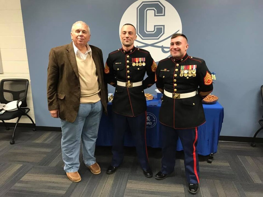 Chillicothe High School head football coach Ron Hinton, left, stands with U.S. Marine Corps Staff Sergeants Zachary Corbin, middle, and James Hopper, with Recruiting Sub-Station Circleville prior to being awarded the 2017 Semper Fi Coach's award Feb. 7, 2017, during halftime of the Chillicothe Cavaliers boys' varsity basketball game. The Semper Fi Coach Award recognizes a high school football coach who exemplifies the Marine Corps motto: Semper Fidelis – always faithful. It is earned by a coach who models the Marine Corps leadership values of honor, courage, and commitment. Hinton is the only coach to receive the award from Marine Corps Recruiting Station Charleston, which covers much of Tennessee, West Virginia, Virginia, Ohio and Kentucky.  (U.S. Marine Corps photo by Sgt. Caitlin Brink/Released)