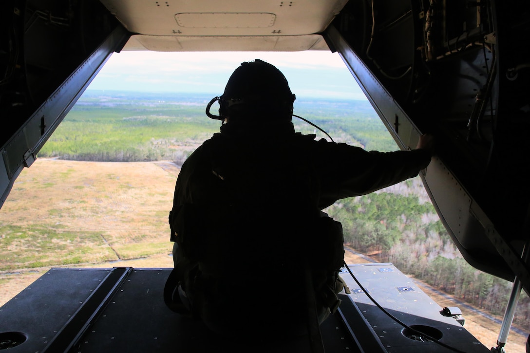 Sgt. Brett Hankins gazes out the back of an MV-22 Osprey as it flies near Marine Corps Air Station New River, N.C., Feb. 9, 2017. Many operations are intensive on Osprey pilots such as aerial refueling, but some flight operations such as external lifts require the pilots to rely on the crew chief. This makes them an essential part to mission accomplishment. Hankins is a crew chief the Marine Medium Tiltrotor Squadron 263, Marine Aircraft Group 26, 2nd Marine Aircraft Wing. (U.S. Marine Corps photo by Cpl. Mackenzie Gibson/Released)