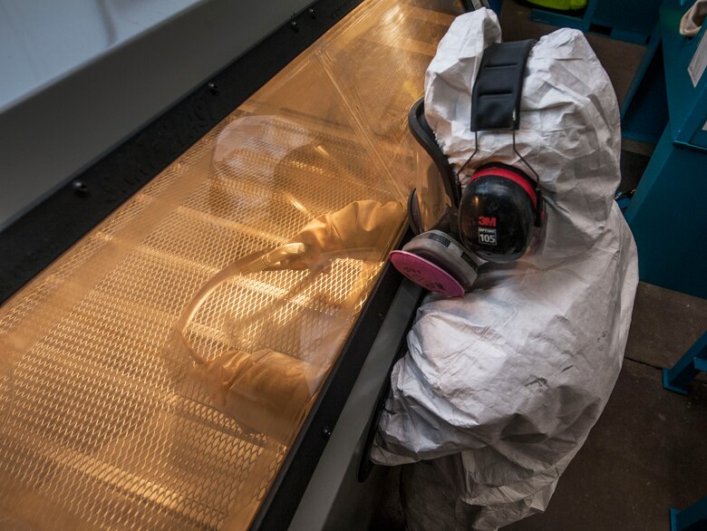 Gerald Ferdon, 91st Missile Maintenance Squadron corrosion control specialist, sandblasts parts at Minot Air Force Base, N.D., Feb. 2, 2017. The corrosion control team uses the sand blasting booth to help minimize the effects of corrosion on equipment used at the 91st Missile Wing missile sites. (U.S. Air Force photo/Airman 1st Class Jonathan McElderry)