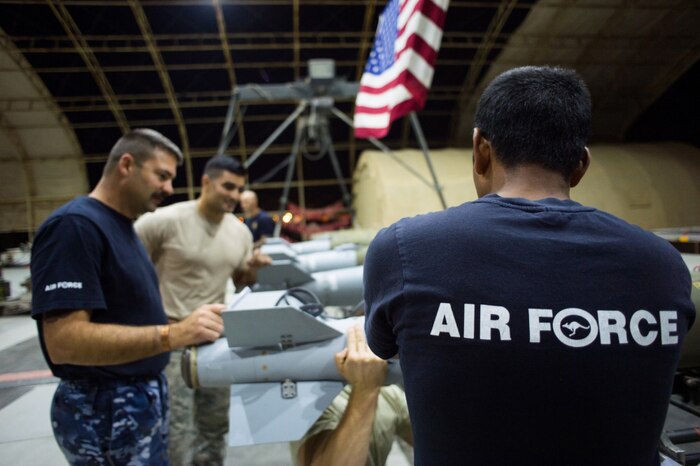 Members of the U.S. Air Force and the Royal Australian Air Force construct Joint Direct Attack Munitions at an undisclosed location in Southwest Asia, Feb. 9, 2017. U.S. Air Force photo by Senior Airman Tyler Woodward