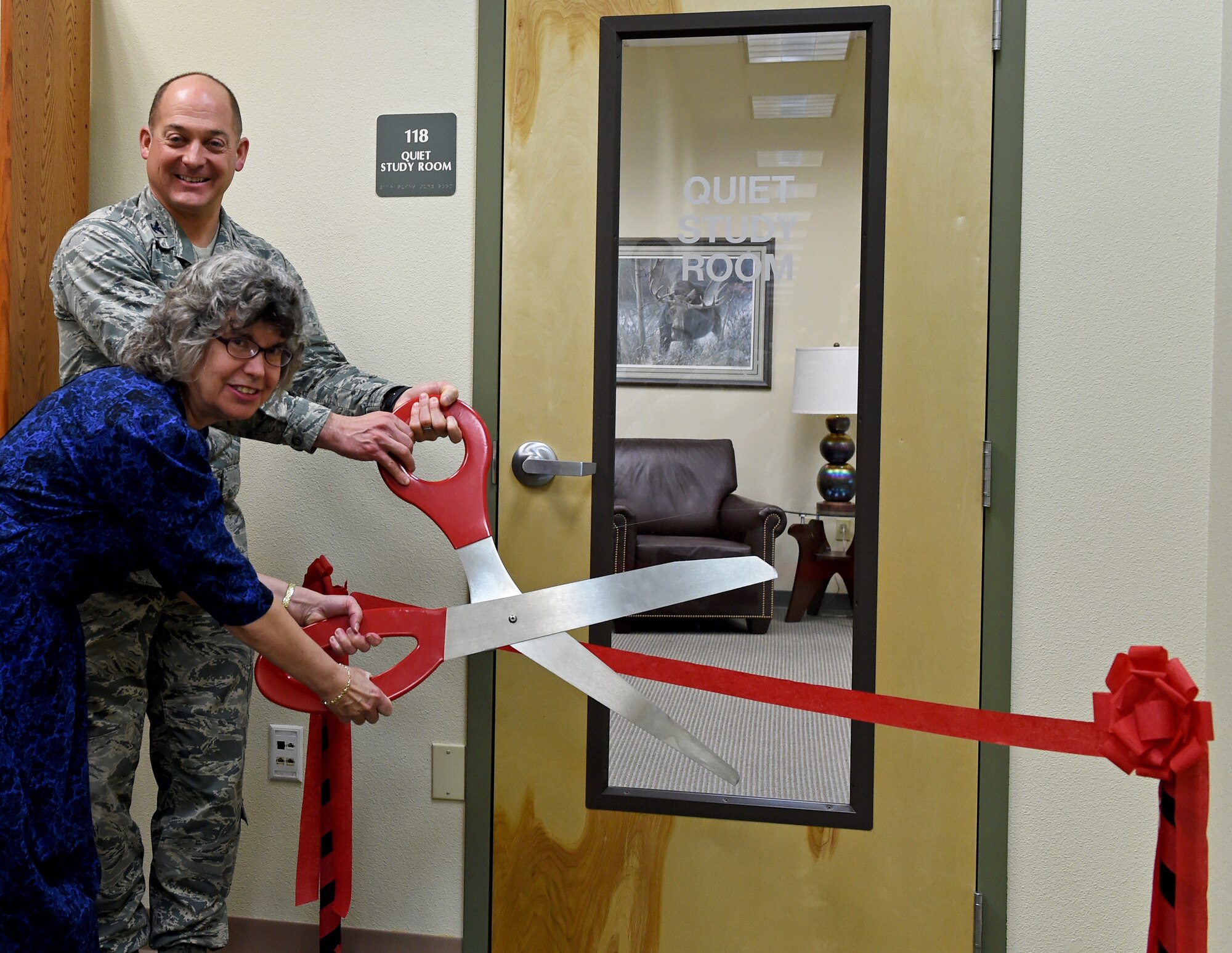 Air Force Col. George T.M. Dietrich III, Joint Base Elmendorf-Richardson and 673d Air Base Wing commander, and Pamela Modelo, JBER Library director prepare to cut the ribbon at the opening of the JBER Library quiet study room, at the JBER Library, Feb. 9, 2017. 
