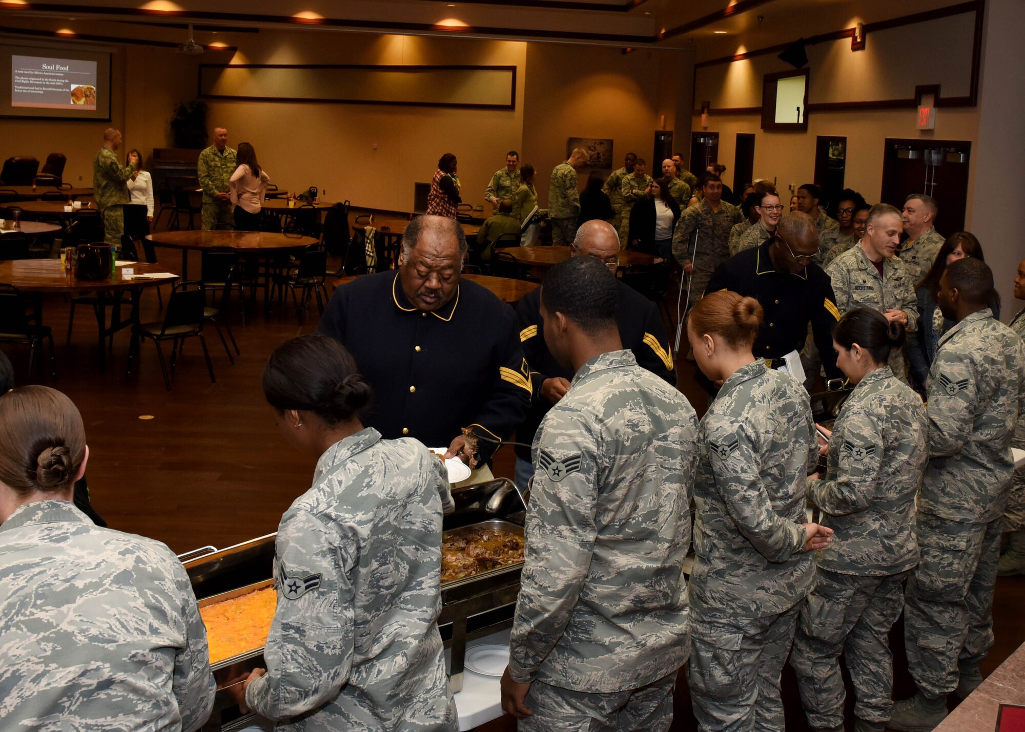 Airmen serve lunch to attendees of the Food for the Soul luncheon and exhibit, Feb. 10, 2017, at Altus Air Force Base, Oklahoma. The luncheon featured traditional soul food and a presentation on the history of the Buffalo Soldiers as part of Altus AFB’s celebration of Black History Month. (U.S. Air Force photo by Senior Airman Nathan Clark/Released)