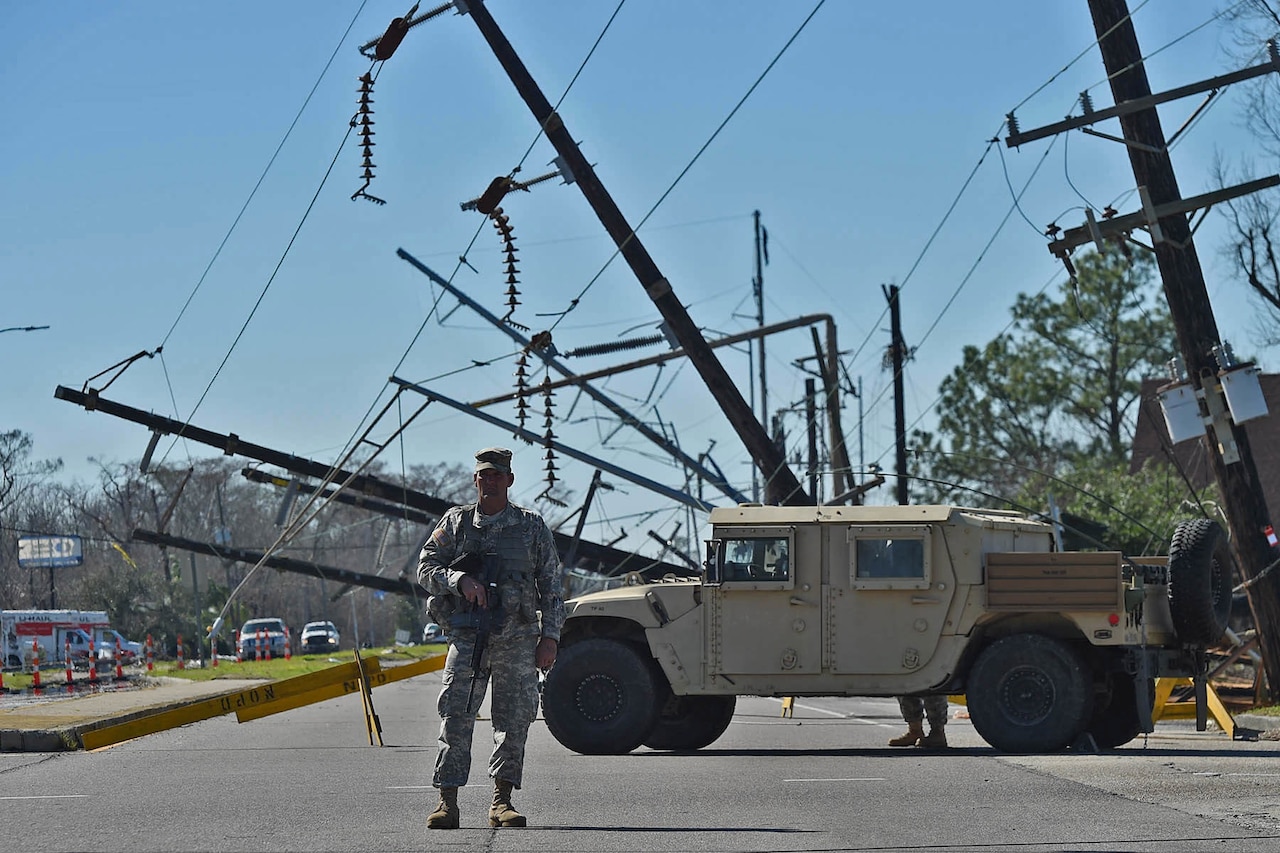 Louisiana National Guard Staff Sgt. Casey Delcambre, 2nd Battalion, 156th Infantry Regiment, 256th Infantry Brigade Combat Team, directs traffic at a static traffic control points in New Orleans East, Feb. 10, 2017. The Guardsmen are working in support of local, parish and state emergency officials after severe thunderstorms spawned several tornadoes in southeast Louisiana. 