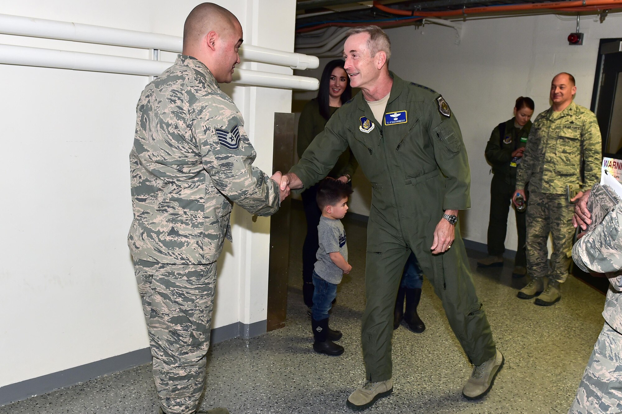 U.S. Air Force Gen. Terrence J. O'Shaughnessy, Pacific Air Forces commander, presents a commander’s coin to Tech Sgt. Keenan Kelley, assigned to the 673rd Air Base Wing, on Joint Base Elmendorf-Richardson, Alaska, as he toured the base, Feb. 7, 2017. O’Shaughnessy toured various facilities throughout the installation to meet with Airmen and get a first- hand look at the broad spectrum of JBER mission sets. 