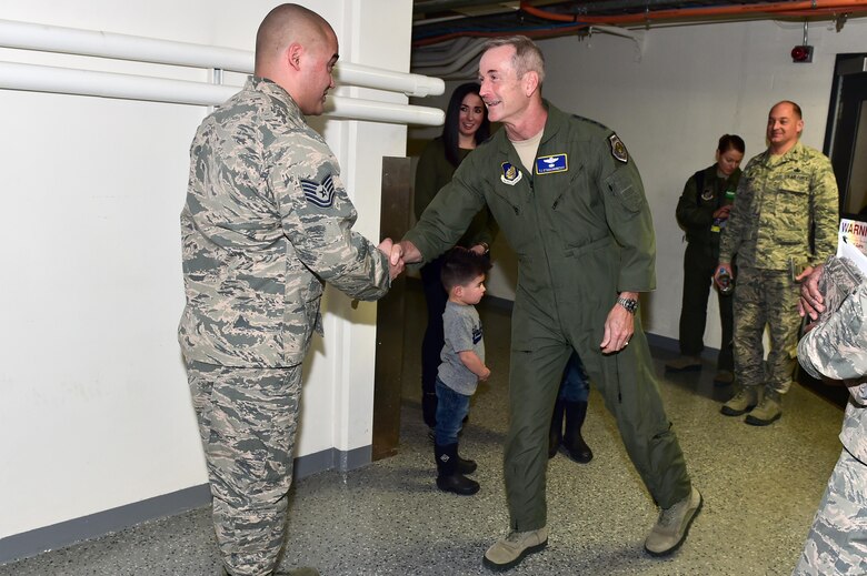 U.S. Air Force Gen. Terrence J. O'Shaughnessy, Pacific Air Forces commander, presents a commander’s coin to Tech Sgt. Keenan Kelley, assigned to the 673rd Air Base Wing, on Joint Base Elmendorf-Richardson, Alaska, as he toured the base, Feb. 7, 2017. O’Shaughnessy toured various facilities throughout the installation to meet with Airmen and get a first- hand look at the broad spectrum of JBER mission sets. 