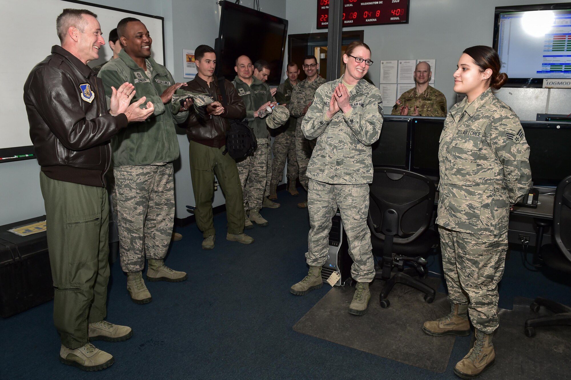 U.S. Air Force Gen. Terrence J. O'Shaughnessy, Pacific Air Forces commander, applauds an Airman after presenting her with a commander’s coin at the Joint Mobility Complex on Joint Base Elmendorf-Richardson, Alaska, as he toured the base, Feb. 7, 2017. O’Shaughnessy toured various facilities throughout the installation to meet with Airmen and get a first-hand look at the broad spectrum of JBER mission sets.