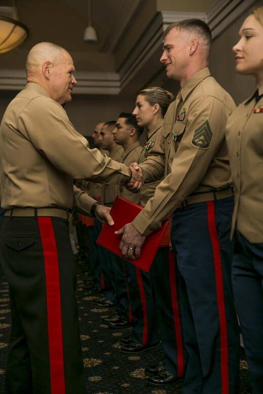 The Commandant of the Marine Corps Gen. Robert B. Neller, shakes the hand of the Active Reserve Career Planner of the Year runner-up, Staff Sgt. Jaim W. Bourg with 4th Reconnaissance Battalion, 4th Marine Division, after awarding him with the Navy and Marine Corps Commendation Medal during the annual Commandant of the Marine Corps’ 2016 Combined Awards Ceremony, Feb. 8, 2017, in Quantico, Va.  Reserve career planners work hard to retain, train and prepare both active duty and reserve Marines for what is next in their future or career that best fits their unique individual needs. 