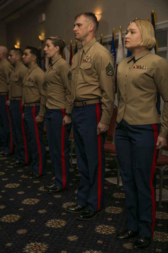 Marine recruiters,  prior service recruiters, drill instructors, combat instructors, career planners and athletes of the year stand at attention at the annual Commandant of the Marine Corps’ 2016 Combined Awards Ceremony, Feb. 8, 2017, in Quantico, Va. Staff Sgt. Christin J. McAdams (right), the Active Reserve Career Planner of the Year, with 6th Communications Battalion, Force Headquarters Group, along with Staff Sgt. Jaim W. Bourg(center), the runner-up, with 4th Reconnaissance Battalion, 4th Marine Division, were both awarded the Navy and Marine Corps Commendation Medal for their hard work and dedication. 