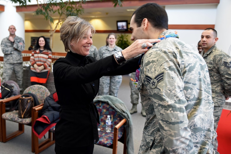 Donna O’Shaughnessy, spouse of Gen. Terrence O’Shaughnessy, commander of Pacific Air Forces, presents a candy-lei to Senior Airman Benjamin Haase, an Airman with the 673d Medical Operation Squadron, at the Joint Base Elmendorf- Richardson (JBER) hospital, Feb. 7, 2017. Mrs. O’Shaughnessy also had the chance to visit with JBER first sergeants’ spouses to discuss current issues and concerns on the installation.