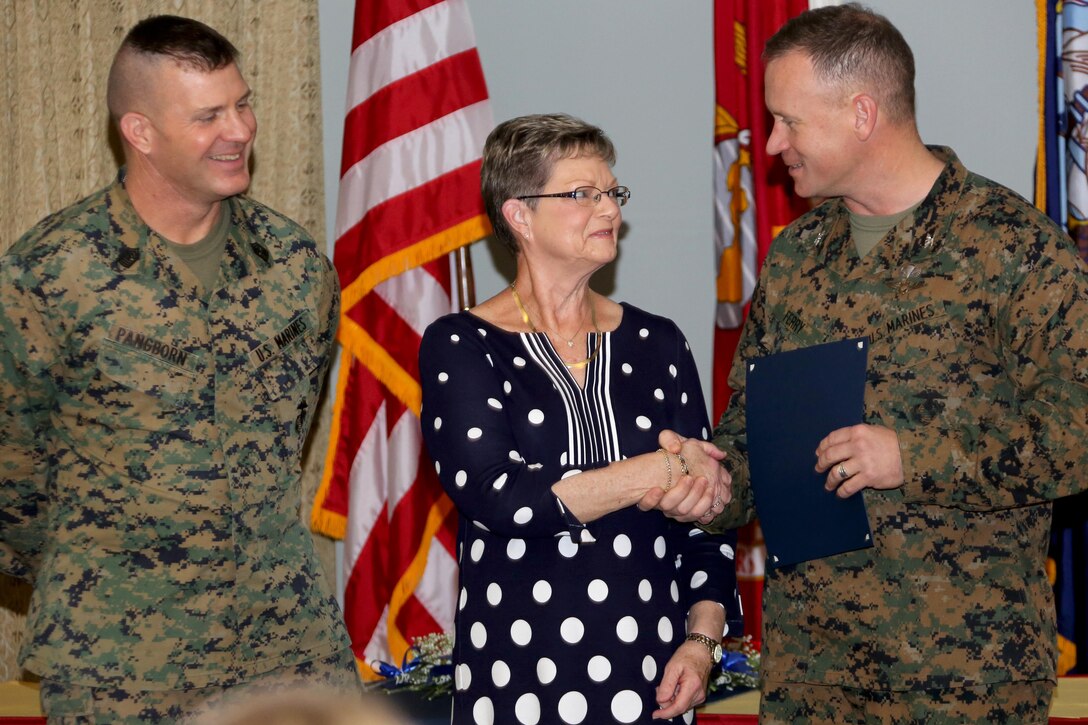 Judy Robison, center, is the recipient of an award of recognition during the Navy-Marine Corps Relief Society’s annual banquet aboard Marine Corps Air Station Cherry Point, N.C., Feb. 9, 2017. “[The NMCRS] has impacted me over 30 years,” said Robison, a volunteer since 1980. NMCRS provides volunteers and employees with the training and resources to be effective, offering consistent services throughout the society. (U.S. Marine Corps photo by Cpl. Jason Jimenez/ Released)