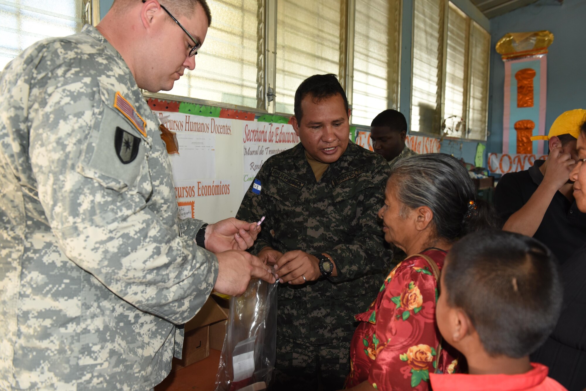 Sgt. Maj. Wilson Carranza from the Honduran Armed Forces Surgeon’s Office and U.S. Army Sgt. 1st Class Bradley Niekamp, Joint Task Force-Bravo Medical Element Preventive Medicine, provide vitamins and deworming medication to a family in Estancia, La Paz during a Medical Readiness Training Exercise Jan. 31. A preventive medicine class was also given where people learned about the importance of sanitary precautions for the prevention of diseases, as well as personal hygiene. (U.S. Army photo by Maria Pinel)