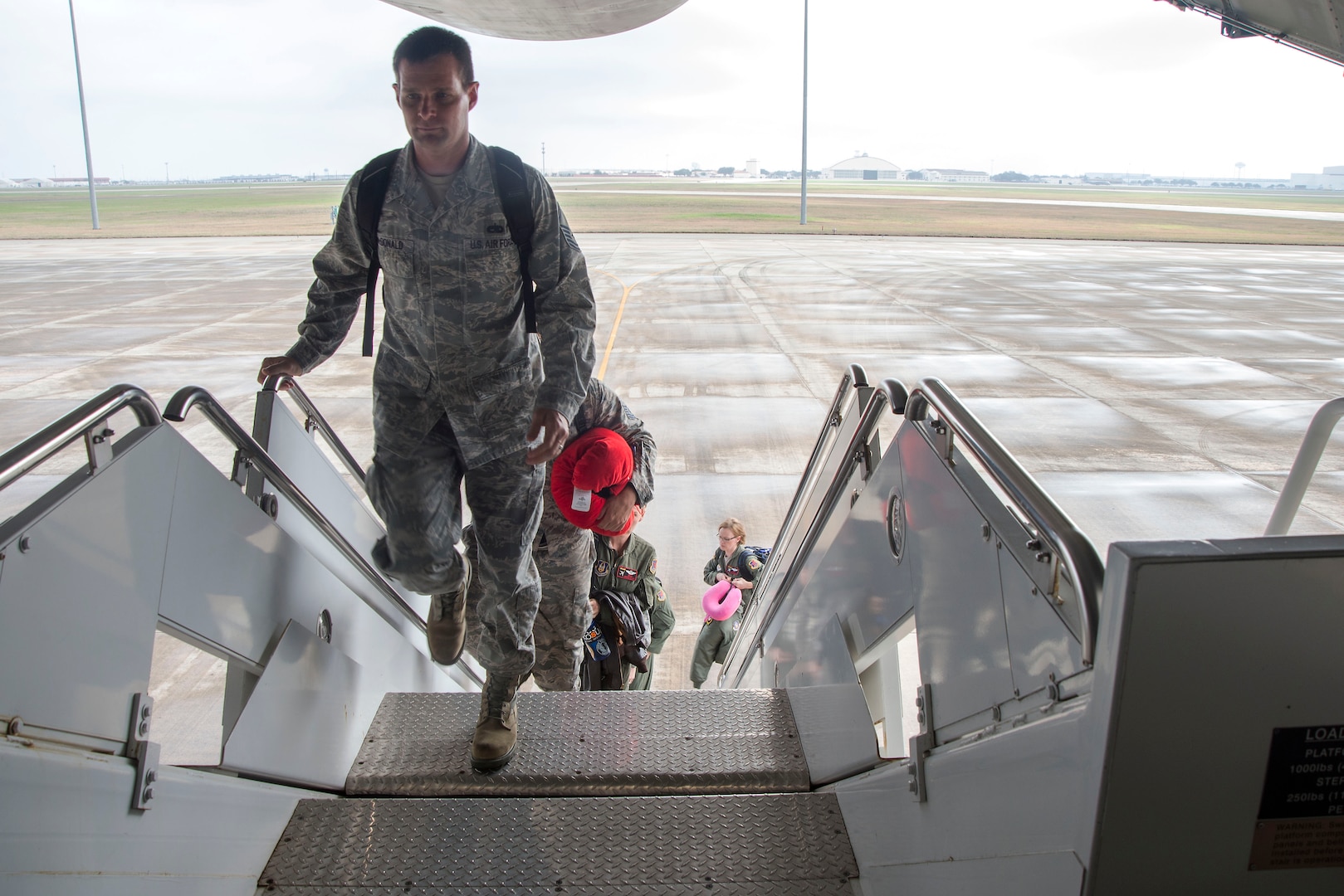 U.S. Air Force service members board a C-5M Super Galaxy from the Joint Base San Antonio-Lackland Passenger Terminal at old Kelly Air Force Base, Texas, Feb. 7, 2017. The JBSA Passenger Terminal offers Space-Available, or Space-A, flights to service members and their dependents and retirees. (U.S. Air Force photo by Airman 1st Class Lauren Parsons/Released)