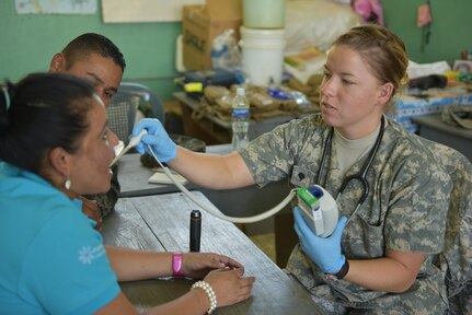 U.S. Army Spc. Rachel Attwood, Joint Task Force-Bravo Medical Element, checks a patient’s temperature during a medical screening prior to seeing a provider as part of a Medical readiness Training Exercise in Estancia, La Paz, Feb. 1. MEDRETES help servicemembers prepare for humanitarian assistance missions in remote areas. (U.S. Army photo by Maria Pinel)