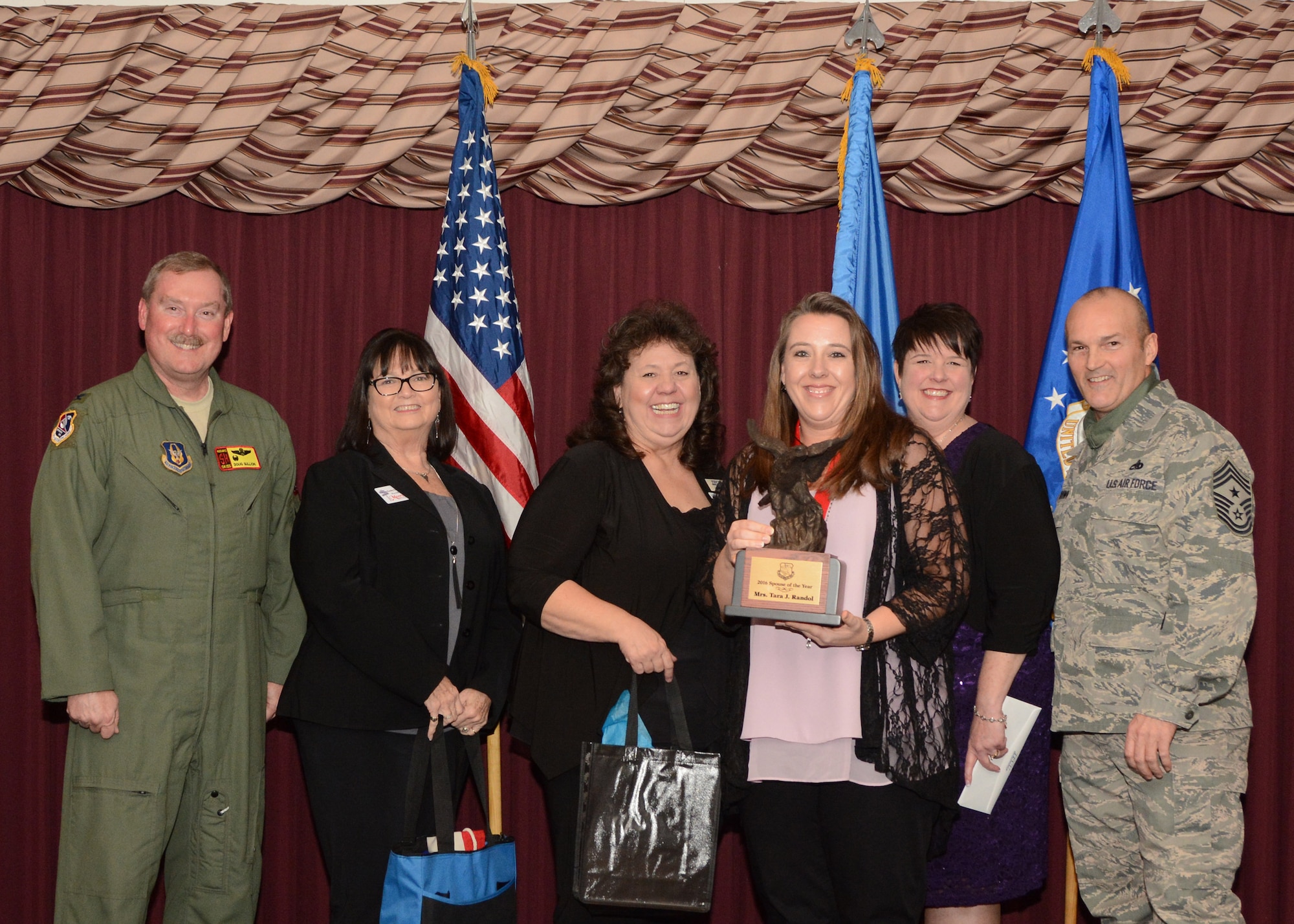 Mrs. Tara Randol, wife of Master Sgt. James Randol of the 507th Civil Engineer Squadron, accepts her award for the 507th Air Refueling Wing Spouse of the Year Feb. 4, 2017 in the Tinker Club Ballroom at Tinker Air Force Base, Okla. Col. Doug Gullion, 507th Air Refueling Wing commander, Jan Davis, assistant vice president and branch manager of Tinker Federal Credit Union, Kathy Gillette, president and CEO of the Moore Chamber of Commerce,  Tanya Windisch, assistant branch manager of Tinker Federal Credit Union and Chief Master Sgt. Stephen Brown, 507th ARW command chief, were on hand to present the award. (U.S. Air Force photo/Tech. Sgt. Lauren Gleason)