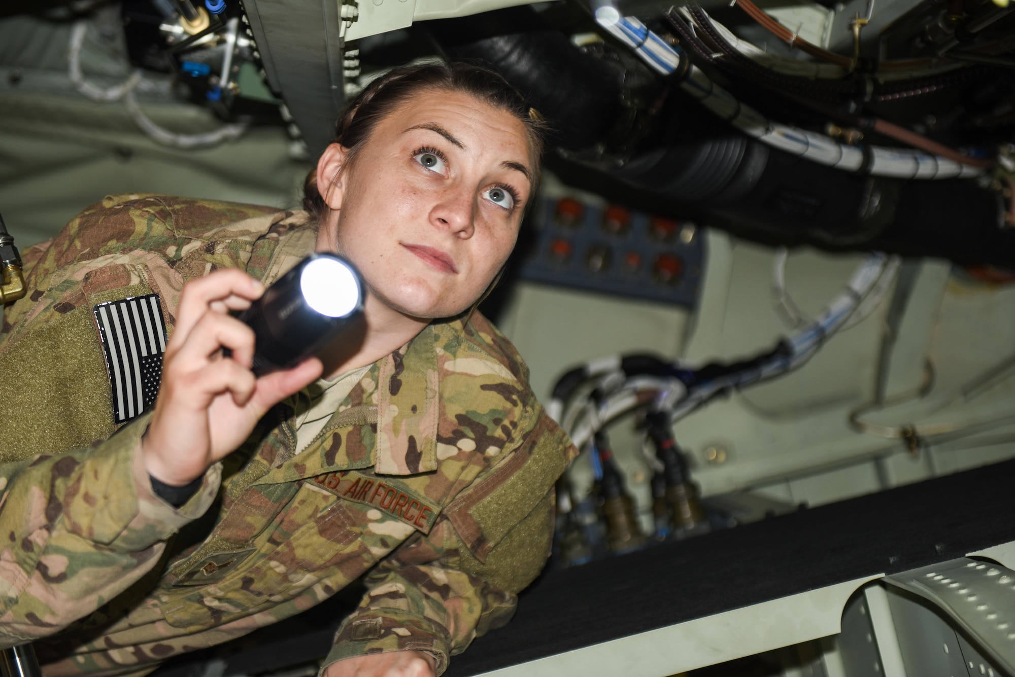 Senior Airman Nicole Pederson, a dedicated crew chief with the 1st Special Operations Aircraft Maintenance Squadron, inspects the wiring of an AC-130J Ghostrider gunship, at Hurlburt Field, Fla., Jan. 27, 2016. Dedicated Crew Chiefs are responsible for managing and supervising all maintenance on their respective aircraft by coordinating with other maintenance specialites such as propulsion, hydraulics and fuels to ensure the aircraft is operational in a timely manner. (U.S. Air Force photo by Senior Airman Jeff Parkinson)