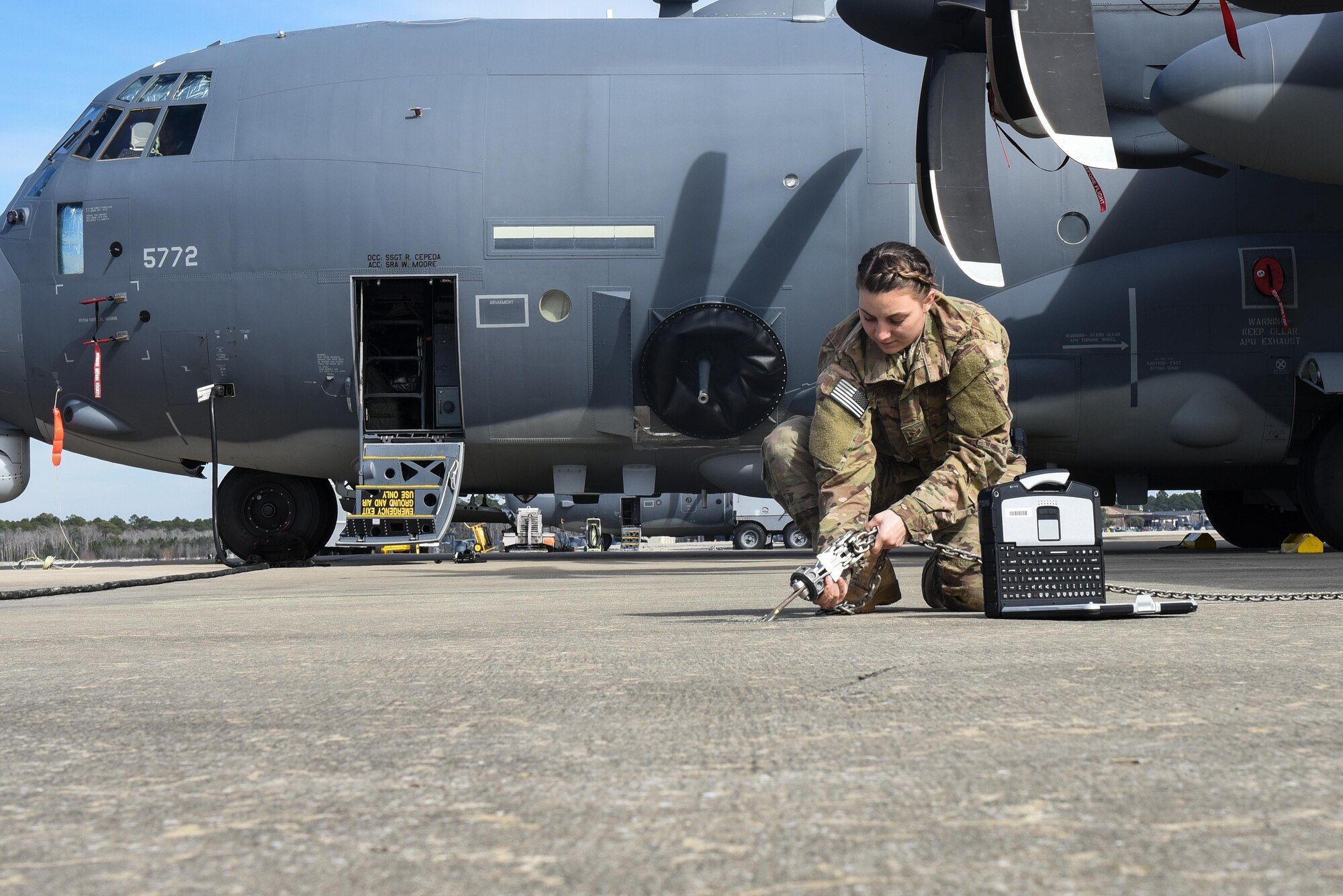 Senior Airman Nicole Pederson, a dedicated crew chief with the 1st Special Operations Aircraft Maintenance Squadron, secures an aircraft tie-down of an AC-130J Ghostrider gunship, at Hurlburt Field, Fla., Jan. 27, 2016. Pederson was named the DCC for the newest AC-130J to arrive at Hurlburt Field. (U.S. Air Force photo by Senior Airman Jeff Parkinson)