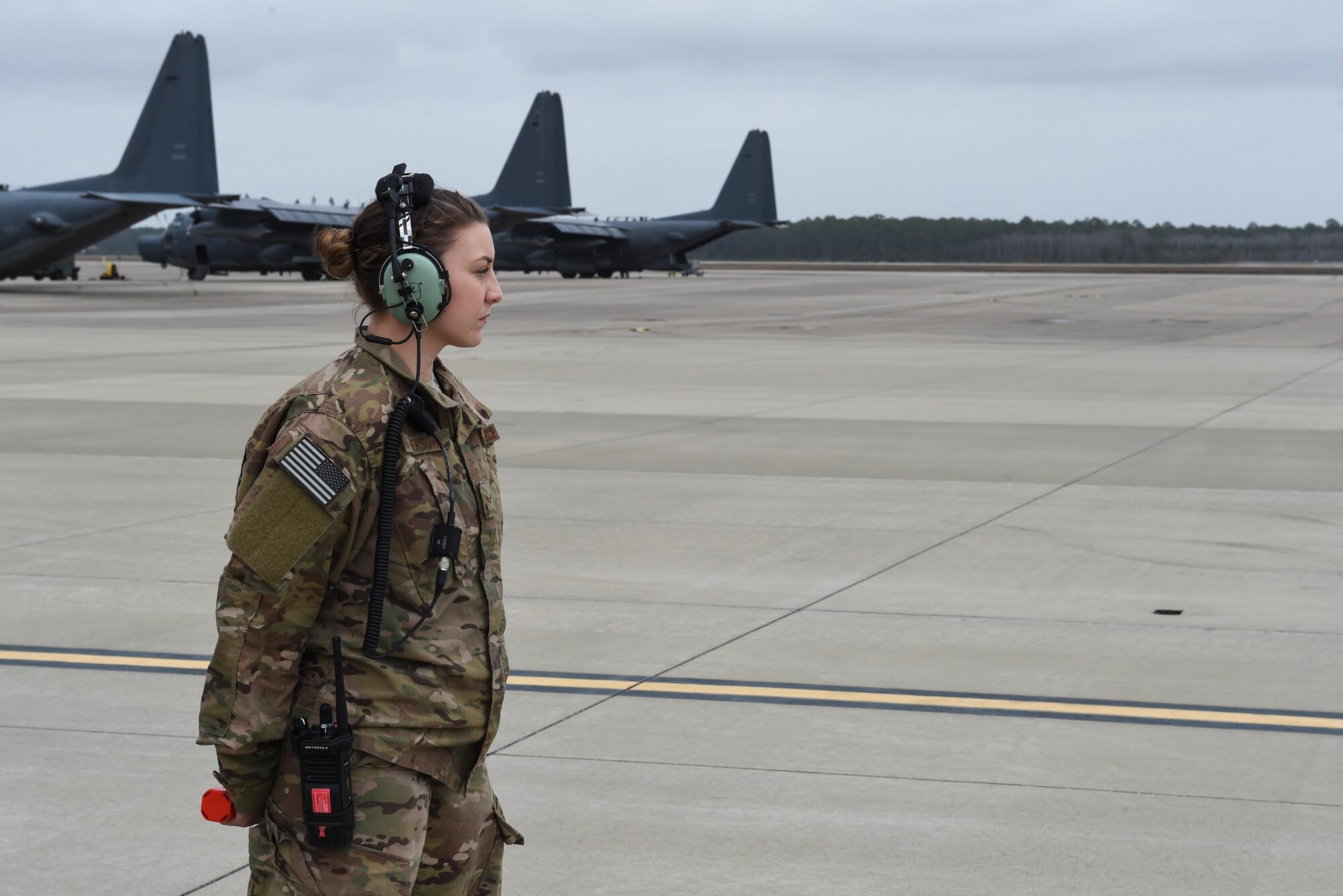 Senior Airman Nicole Pederson, a dedicated crew chief with the 1st Special Operations Aircraft Maintenance Squadron, awaits to marshal in an AC-130J Ghostrider gunship at Hurlburt Field, Fla., Jan. 10, 2017. Pederson was named the DCC for the newest AC-130J to arrive at Hurlburt Field. (U.S. Air Force photo by Senior Airman Jeff Parkinson)