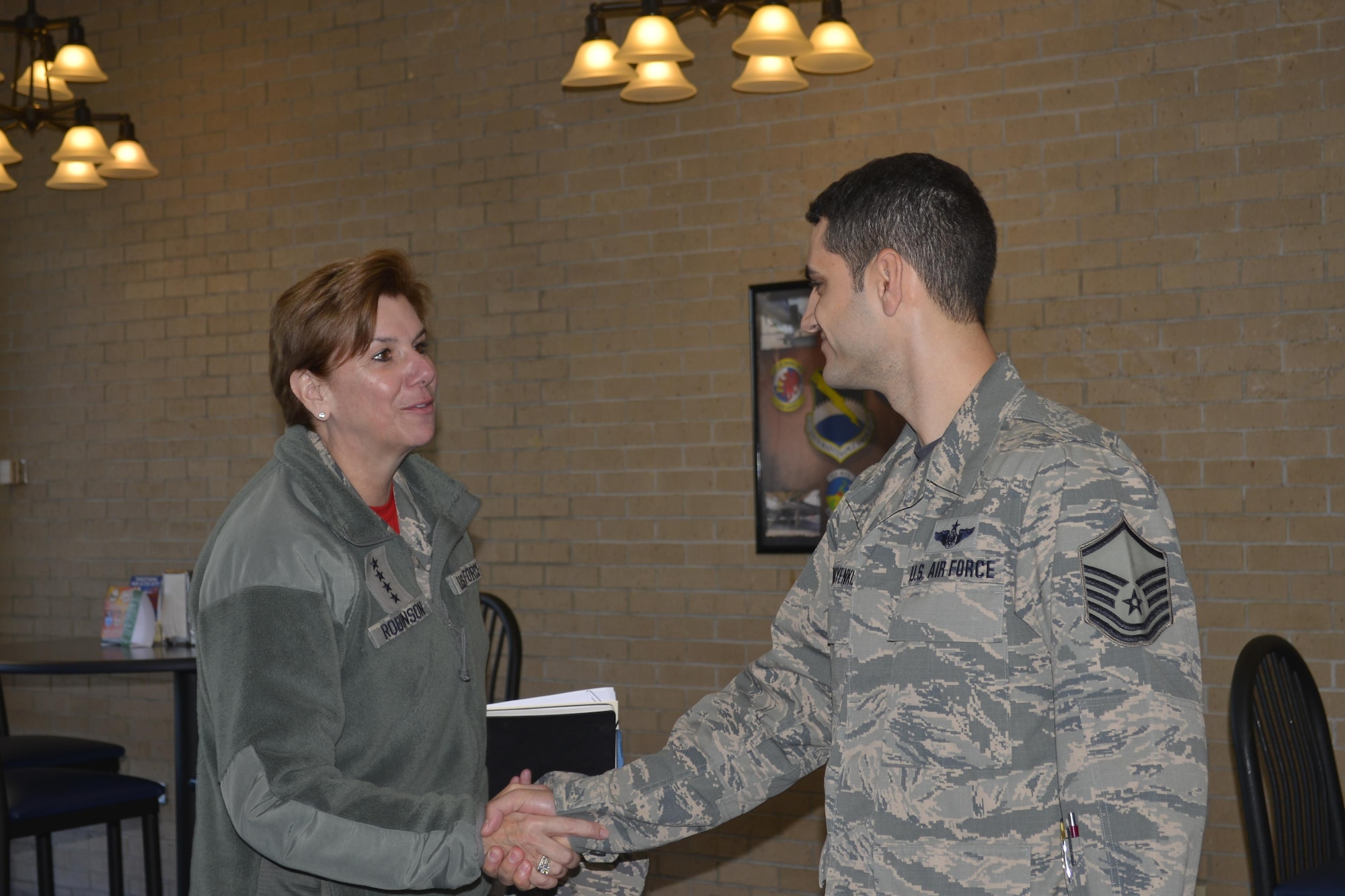 Gen. Lori Robinson, Commander, North American Aerospace Defense Command and United States Northern Command, greets Master Sgt. Samvel Korniyenko, 601st Air Operations Center, at an Airman’s breakfast event here Feb 10. Throughout her Feb. 9-10 visit to the Continental U.S. North American Aerospace Defense Command Region-1st Air Force (Air Forces Northern) enterprise, Robinson talked with organization members about her priorities and expressed her deep appreciation for their professionalism and unwavering commitment to the CONR-1st AF (AFNORTH) mission. (Photo by Mary McHale)