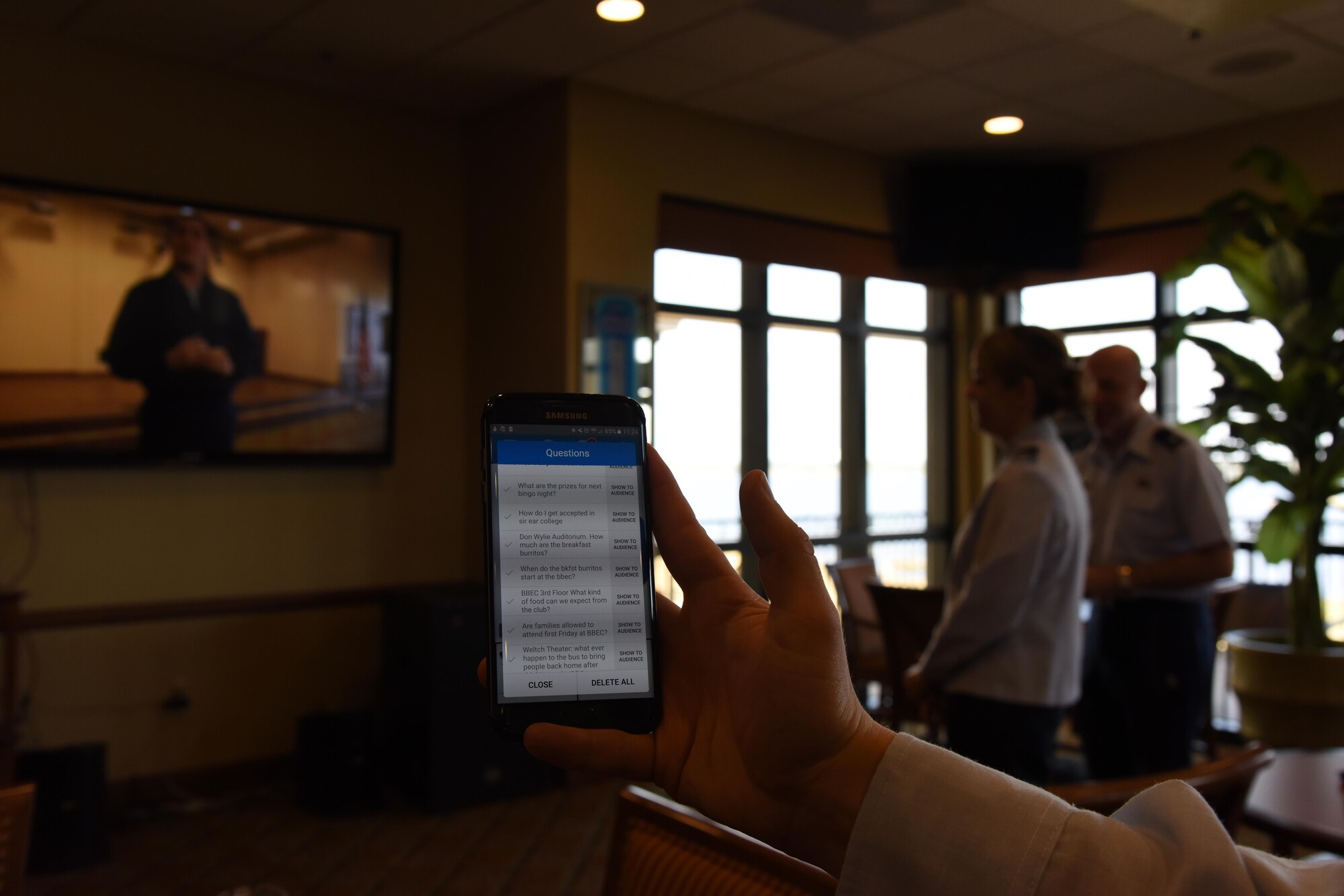 A cell phone displays a list of sample question during a live multimedia broadcast system demonstration at the Bay Breeze Event Center Feb. 6, 2017, on Keesler Air Force Base, Miss. The conferencing system provides a way for someone at the BBEC to communicate with up to five locations on base via a livestream. (U.S. Air Force photo by Kemberly Groue)
