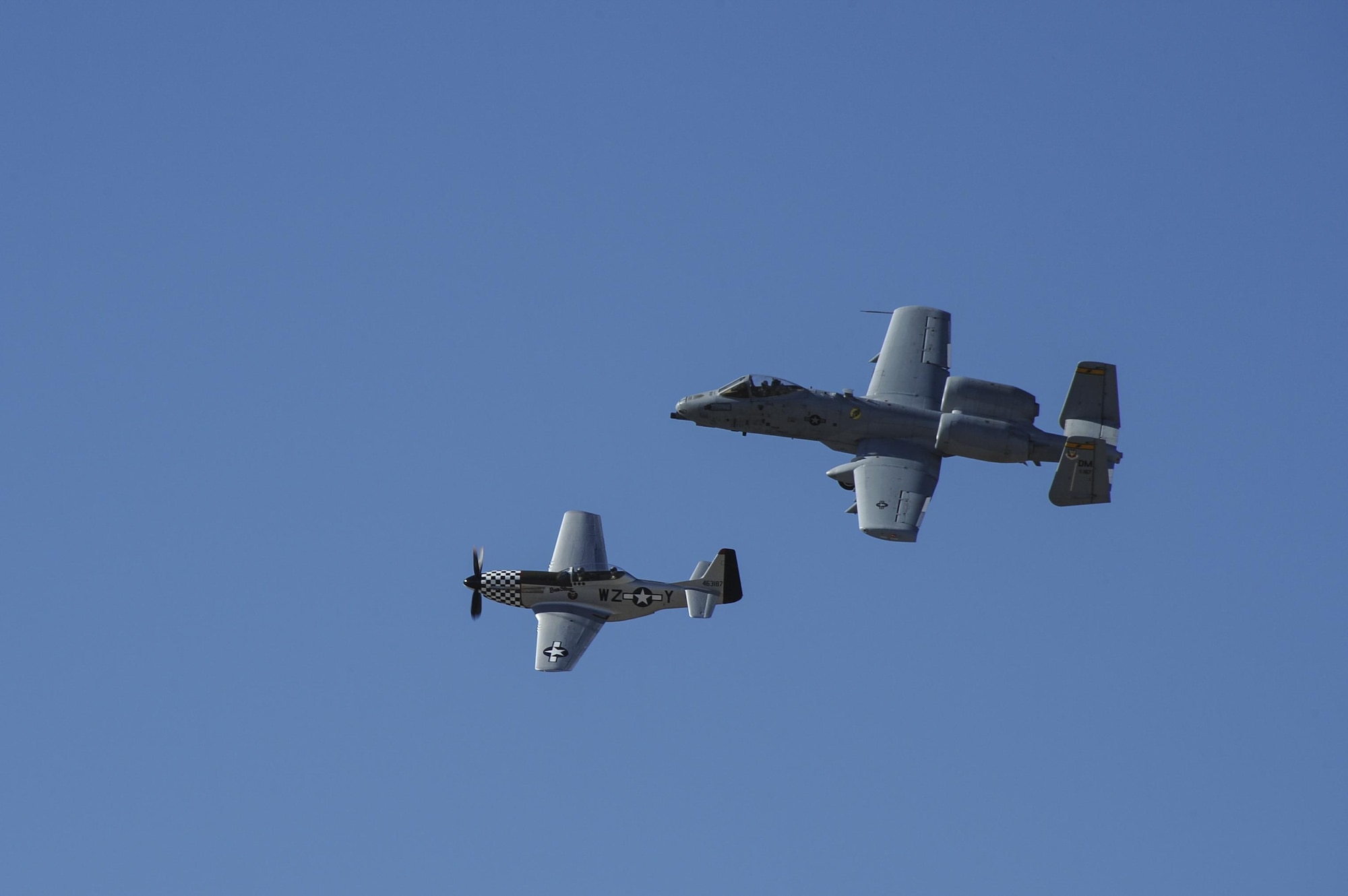 A U.S. Air Force A-10C Thunderbolt II and a TF-51 Mustang fly together during the 2017 Heritage Flight Training and Certification Course at Davis-Monthan Air Force Base, Ariz., Feb. 10, 2017. The annual aerial demonstration training event has been held at D-M since 2001, the course featured aerial demonstrations from historic and modern fighter aircraft. (U.S. Air Force photo by Airman 1st Class Mya M. Crosby)